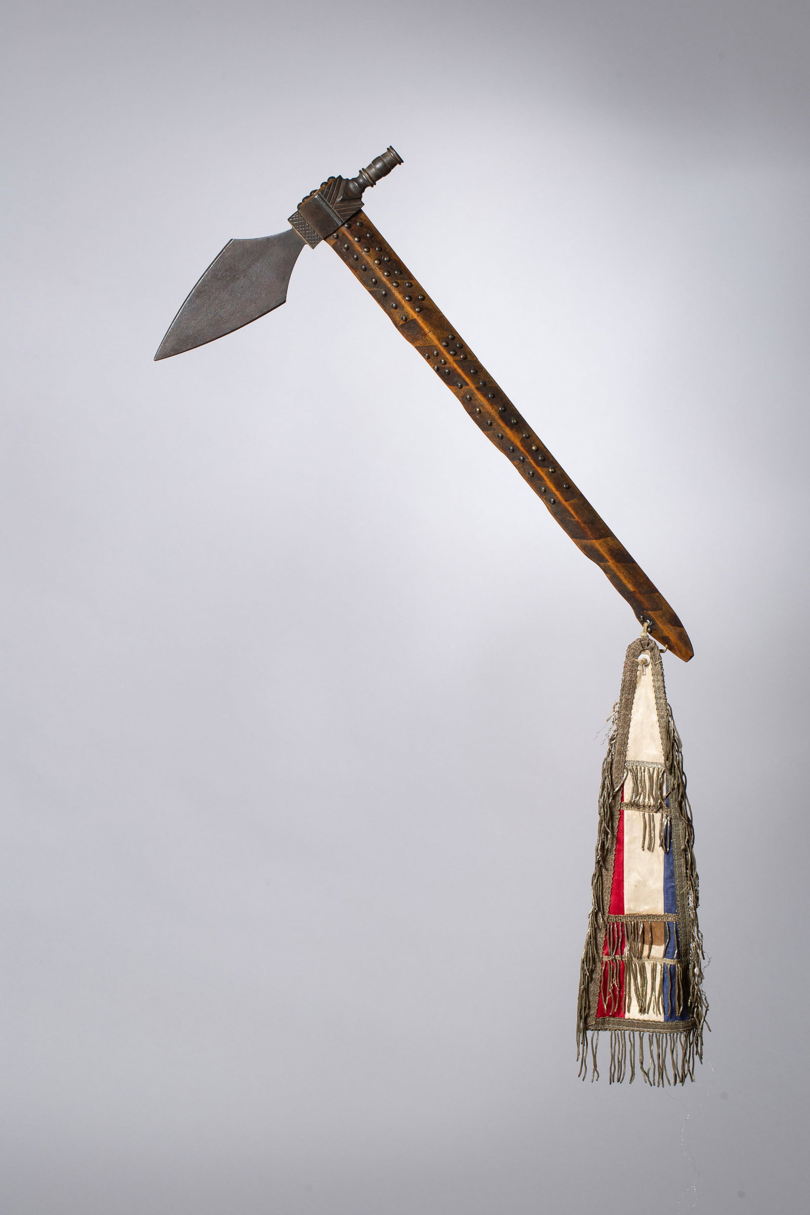 Presentation Pipe Tomahawk, inscribed to a Lakota chief, 1890: Forged iron pipe-tomahawk head with stepped shoulders, containing the words "U S • Chief Sitanka • Lakota • Warrior • Friend • Leader • 1890", pierced at the butt for a h