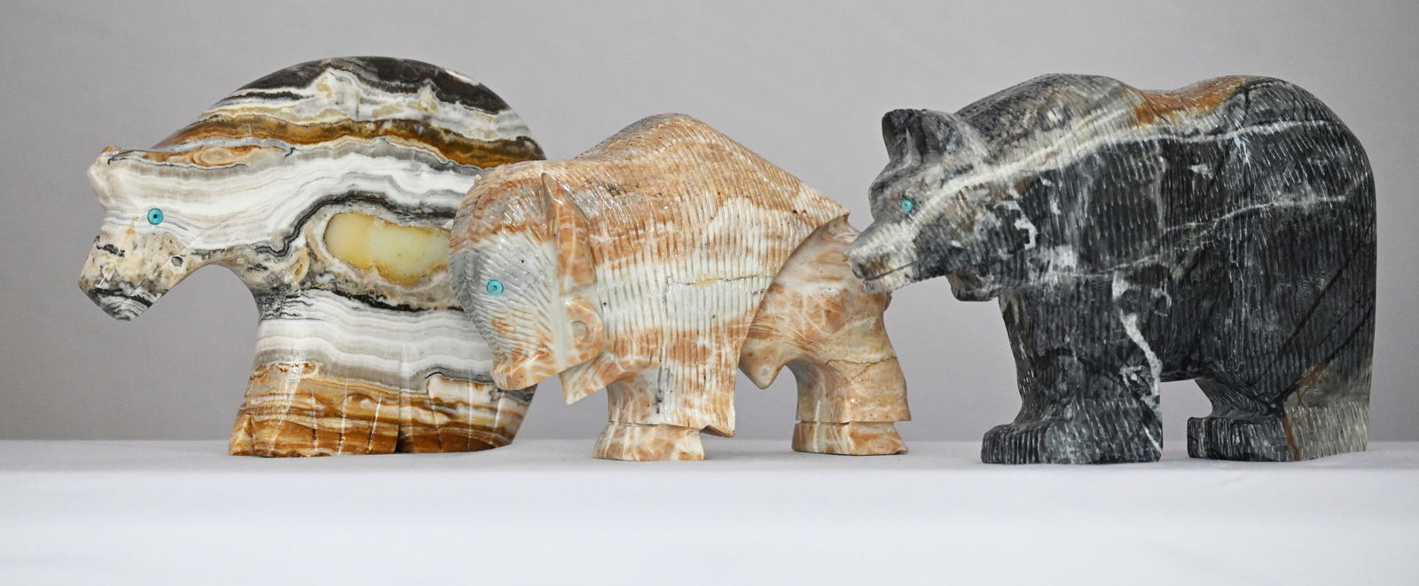 Lot of Three Hand Carved Sculptures of Marble and Onyx: 1) Navajo Marble Buffalo 3 3/4" height, 5 1/4" width, 1 1/2" depth, 1.59 pounds 2) Navajo Picasso Marble Bear 4" height, 5 3/4" width, 1 3/4" depth, 2.54 pounds 3) Navajo Mexican Onyx Spirit Bear 4 1/