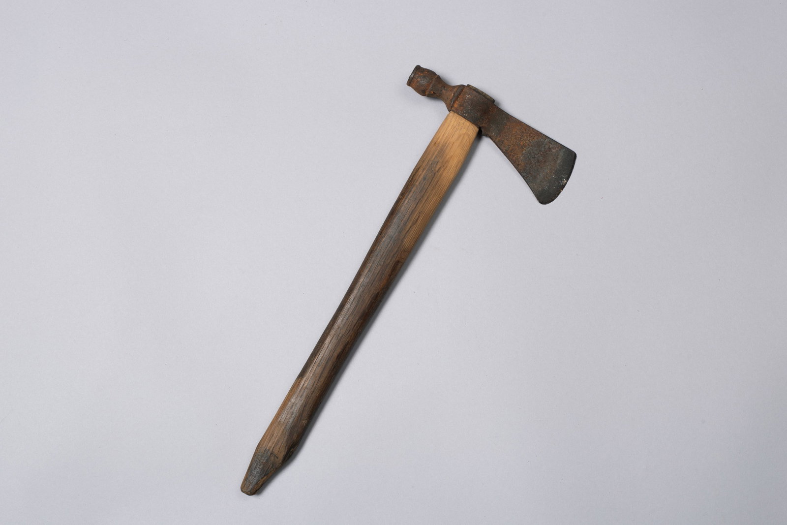 Lot of 2 Native American Weapons, 1) Plains Pipe Tomahawk 2) Central Plains Beaded War Club: 1) Forged iron tomahawk head, the blade showing a wide cutting edge and a gently curved profile14.75" length; 6" Blade/Pipe 2) wrapped rawhide, adorned with a long fringe and featuring red, white, blu