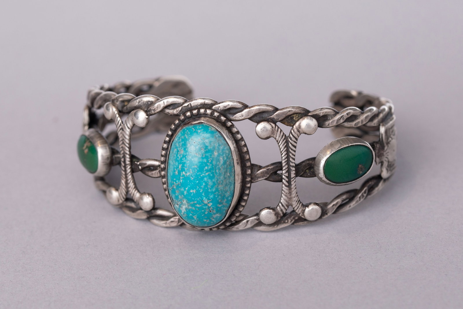 Fred Harvey Era Cuff Bracelet with Three Turquoise Stones, Braided Silver, and Thunderbirds: Stamped sterling silver, Ca. 30-40s5 1/4" Internal Circumference1 1/4" Gap, 1 1/8" Width, 37 grams