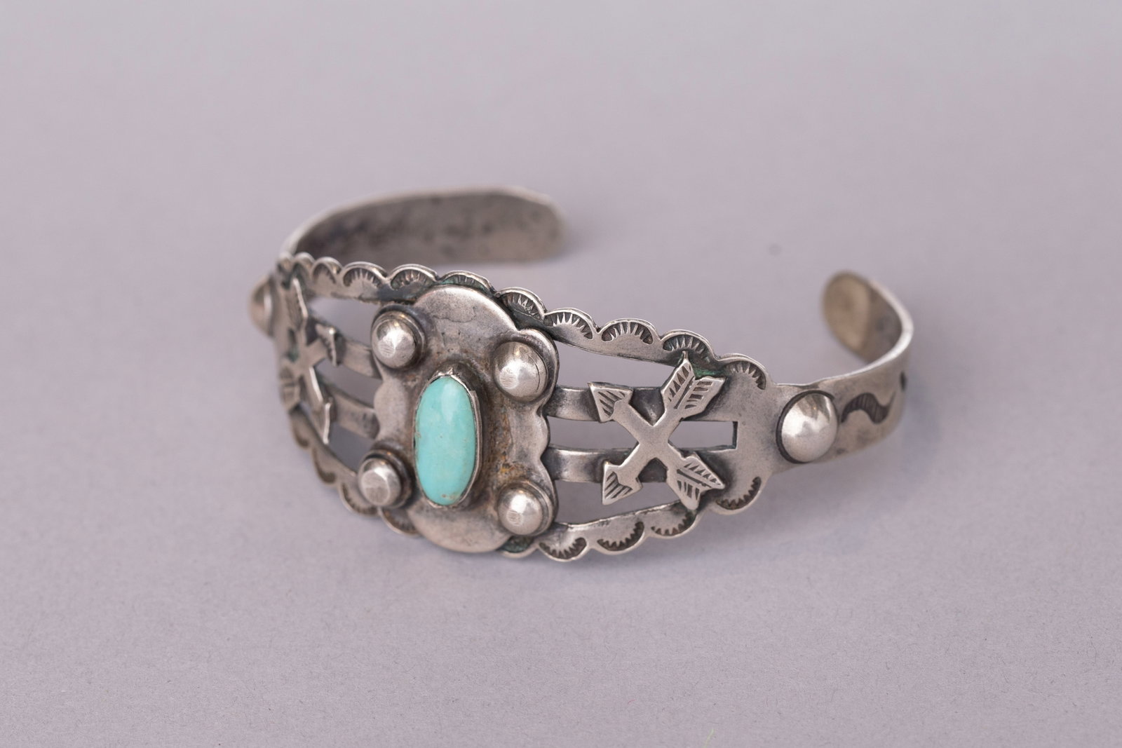 Vintage Fred Harvey Cuff Bracelet with Central Turquoise stone between 2 sets of Crossed Arrows and: Stamped sterling silver, Ca. 30-40s5 1/2" Internal Circumference1 1/8" Gap, 1 1/8" Width, 22 grams