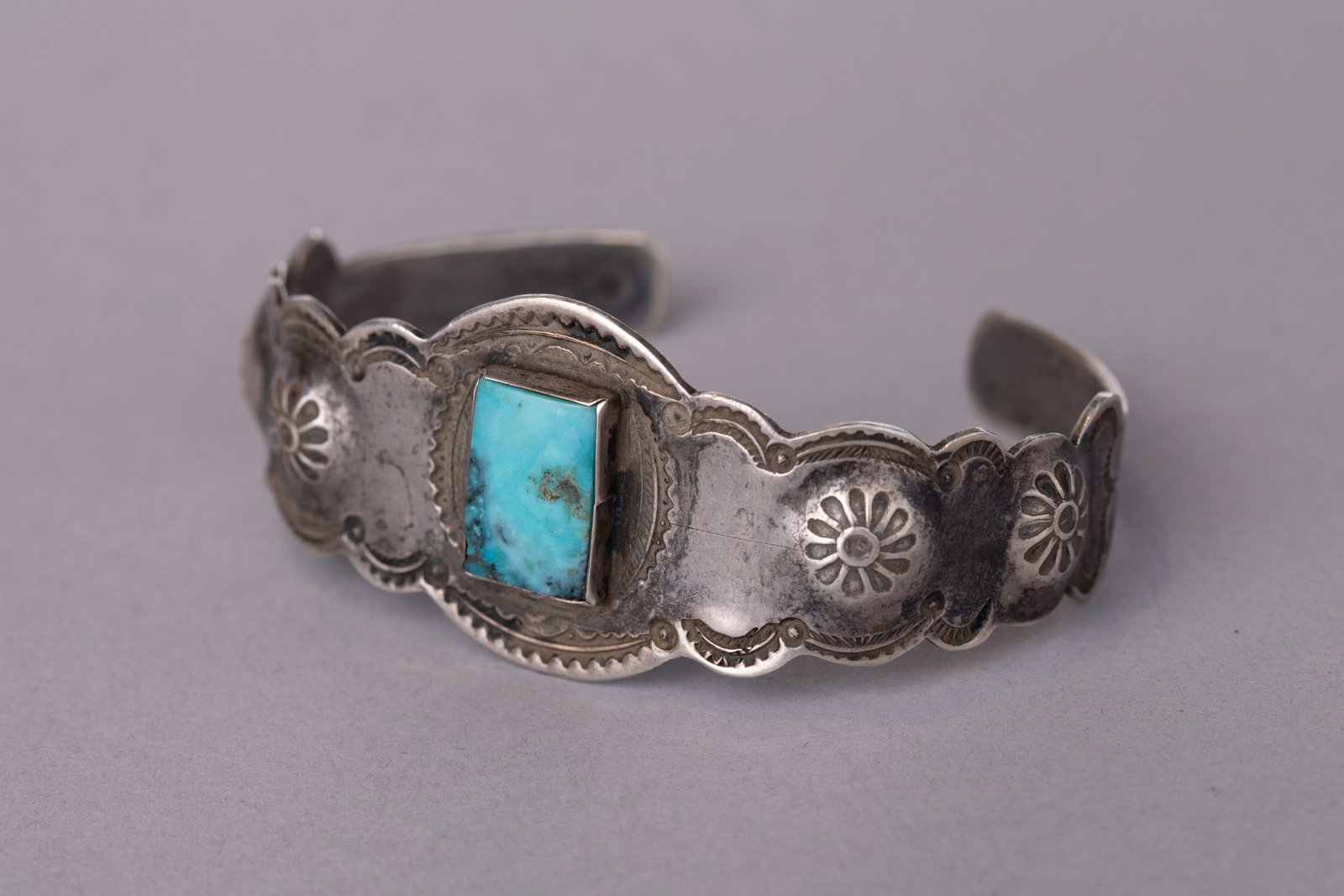 Vintage Fred Harvey Cuff Bracelet with Rectangle Turquoise Center Stone: Stamped sterling silver, Ca. 30-40s; 5 5/8" Internal Circumference1" Gap, 1 1/8" Width22 grams