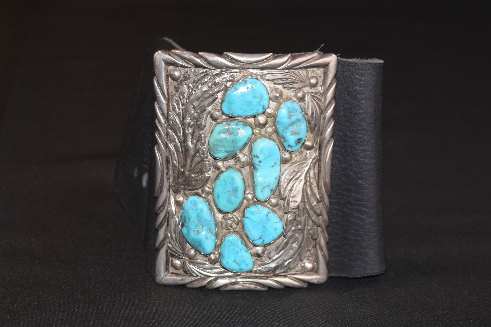 Navajo Silver and Turquoise Ketoh: Bow guard of black leather and sterling silver with eight nice turquoise stones; 11 1/4" Internal Circumference; Silver 3" x 4"; 196 grams