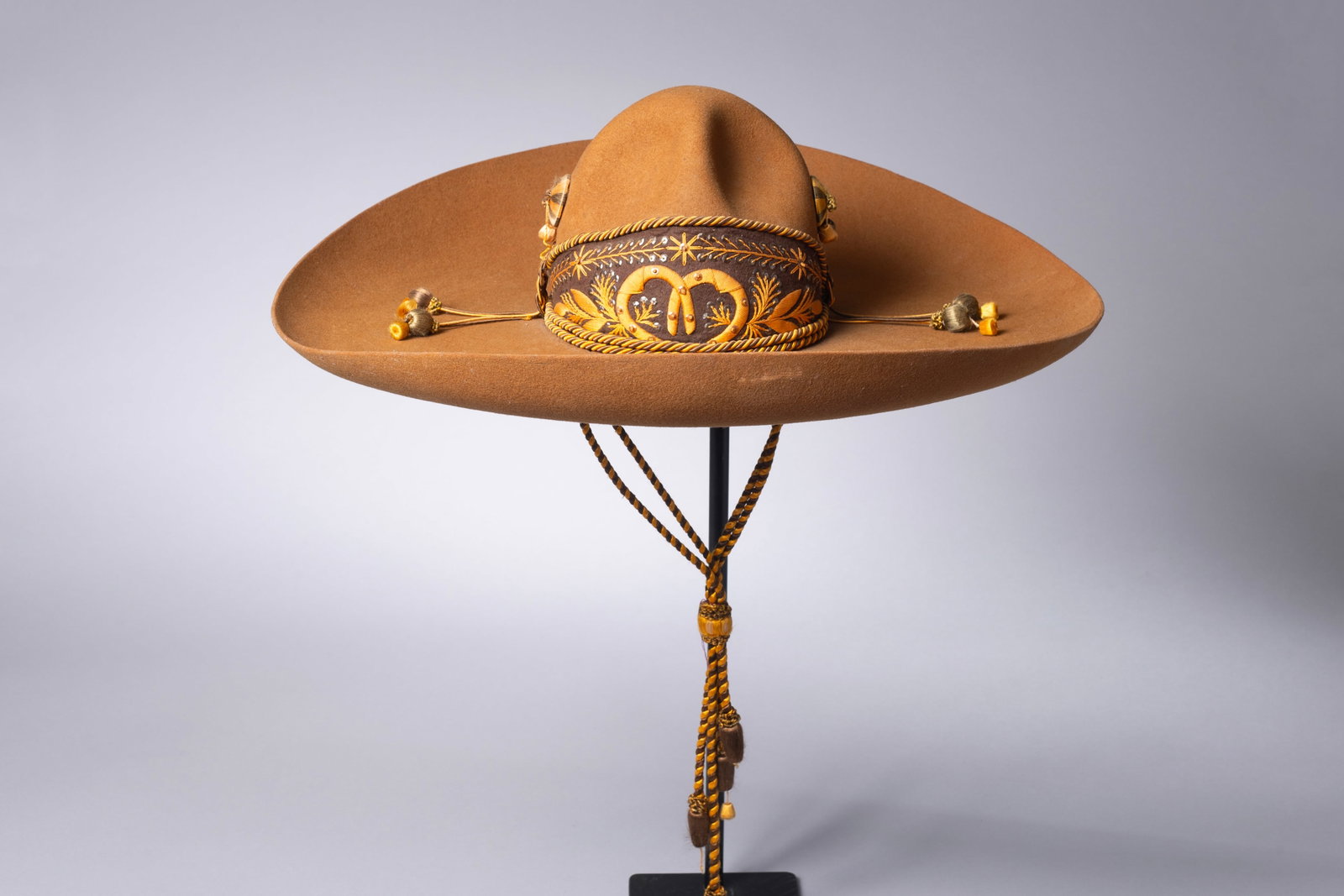 Vintage Brown Charro Sombero: Fancy Brown Charro Sombero, elaborate stitching with horseshoes and feathers on dome. Stamped "Tardan Mexico" on sweatband. 21"D, 7"H