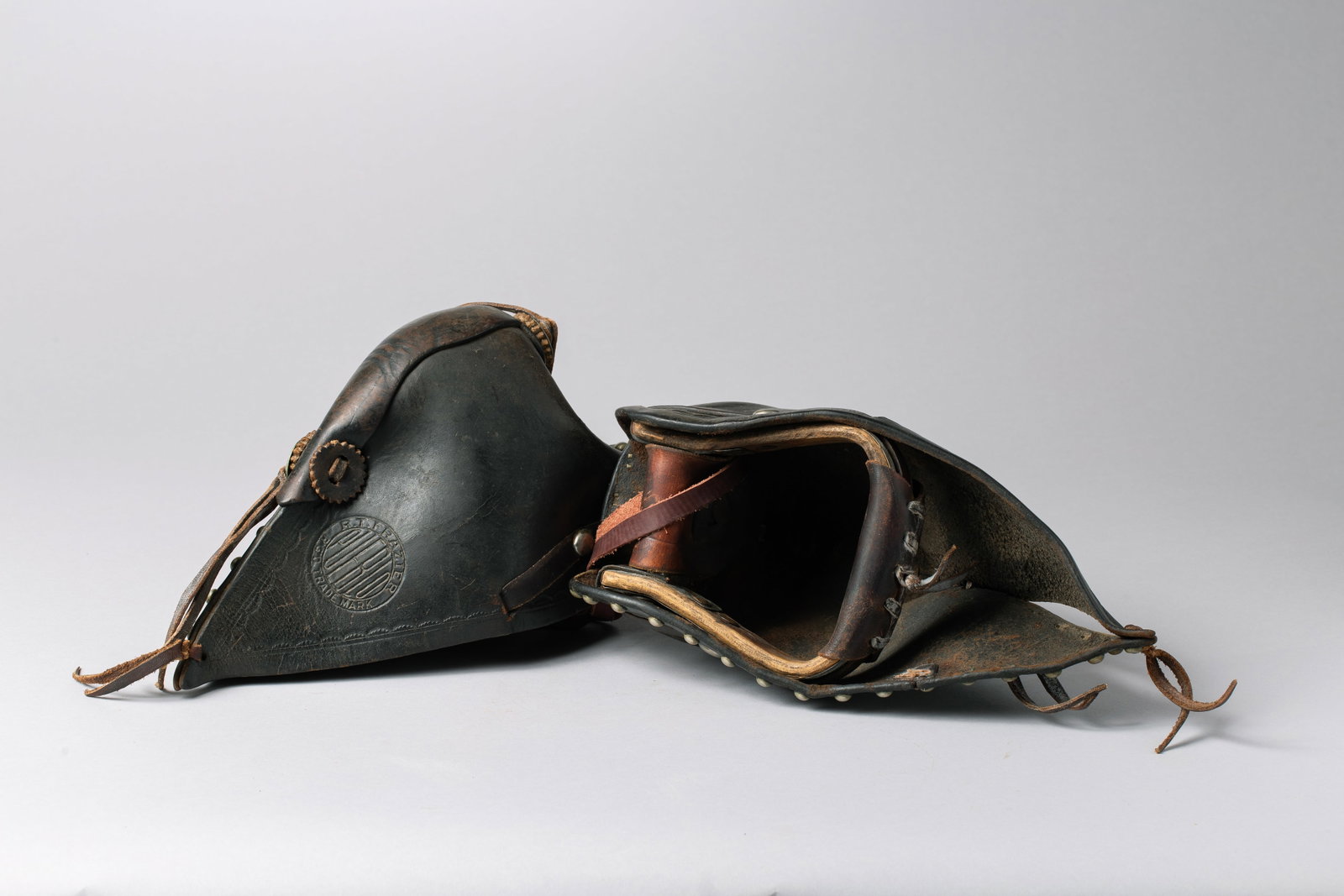 Great set of R.T. Frazier, Pueblo CO Tapaderos: Deep brown color, tooled in a diagonal pattern with silver tacks and conchos, stamped "R.T. Frazier, Pueblo, R.G.D. TRADEMARK". 13 1/2"Long, CA. 1920s-30s