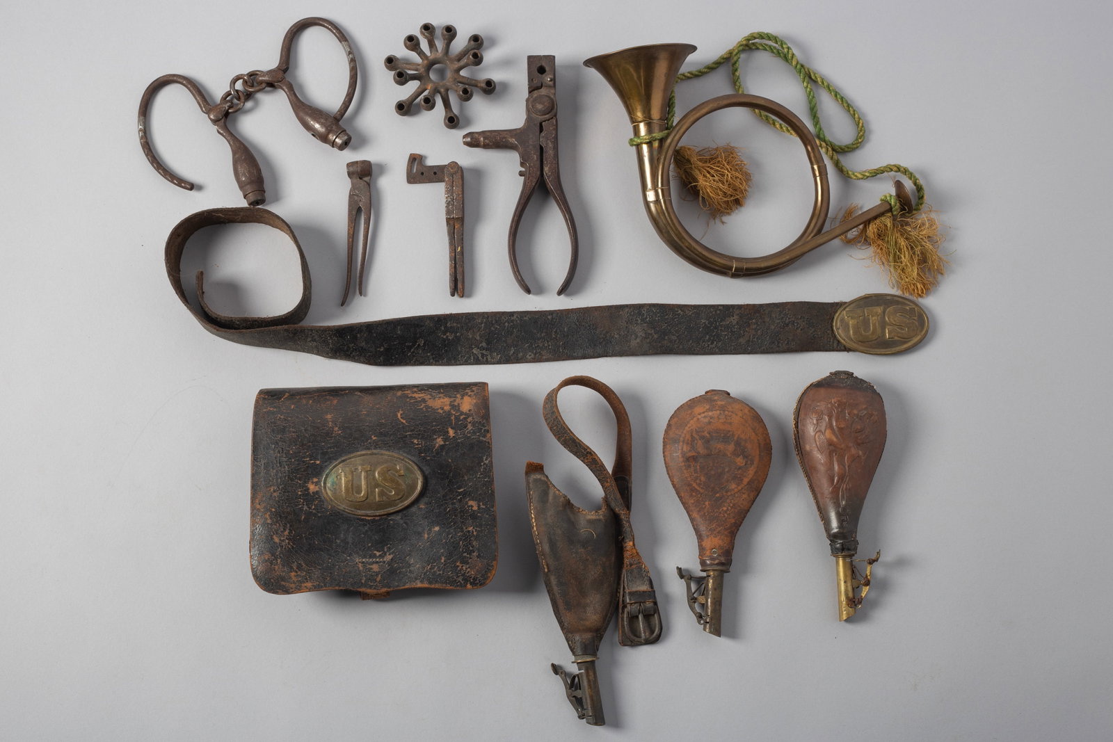 Assortment of US Civil War Items: Various Civil War items, Bugle, bullet molds, handcuffs and ammo pouch.