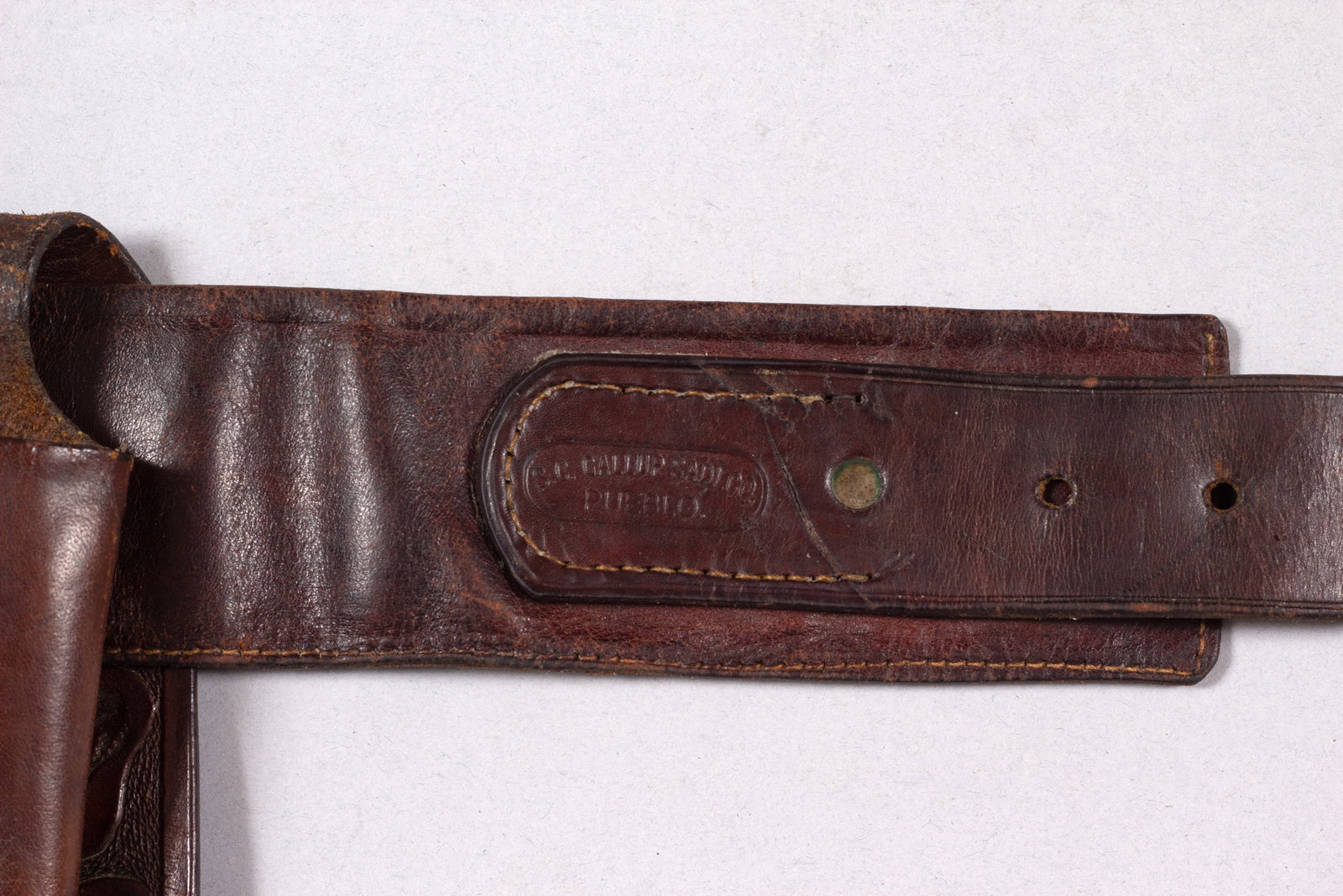 S.C. Gallup Gun Rig, Pueblo, CO: Marked "S.C. GALLUP SADL CO. PUEBLO" on both belt and holster. Belt has a silver buckle and loops to accommodate 36 cartridges. Belt measures 39"L