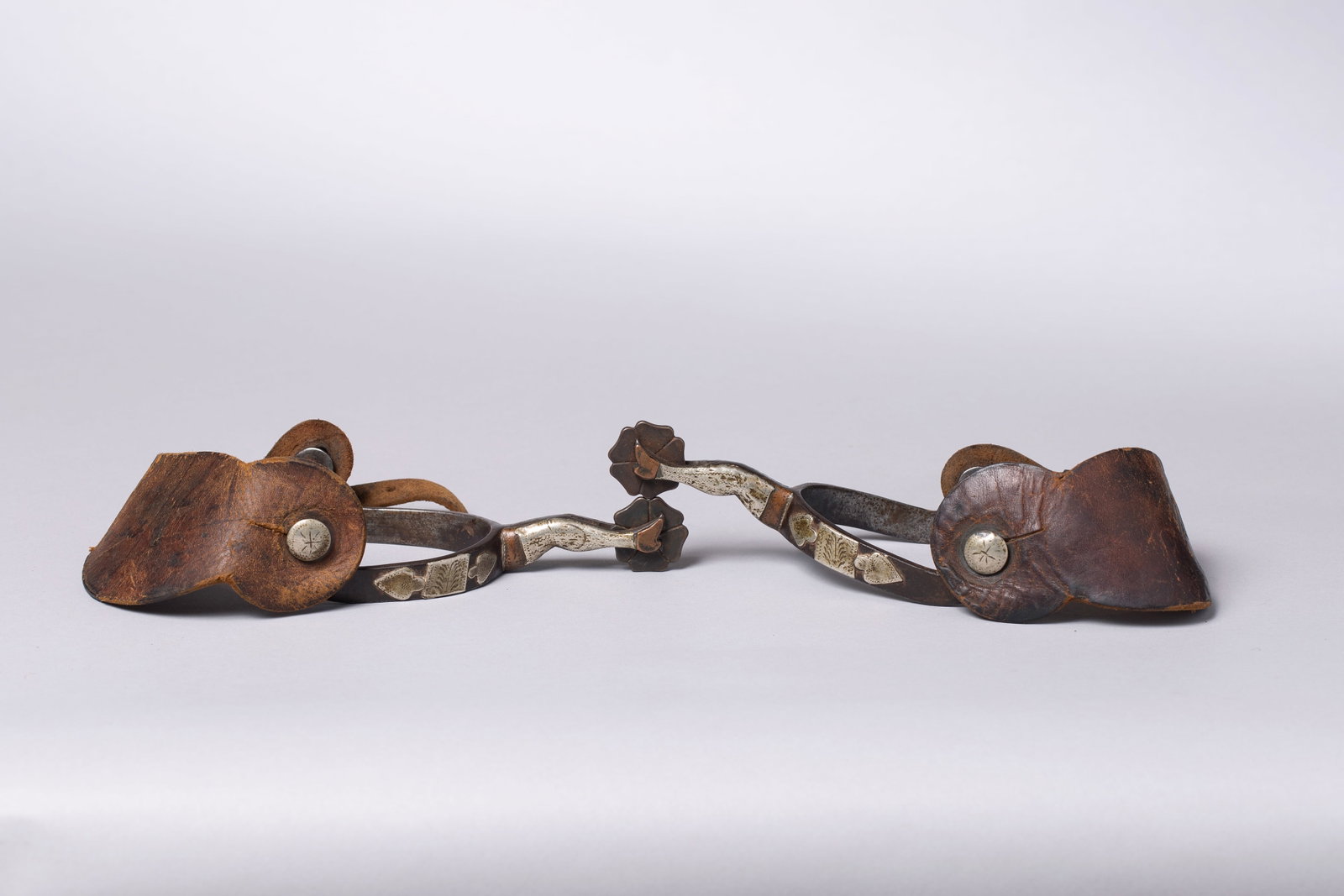 McChesney Gal Leg Spurs: Double mounted gal-leg spurs, 1" shamrock rowels. Period leather straps.