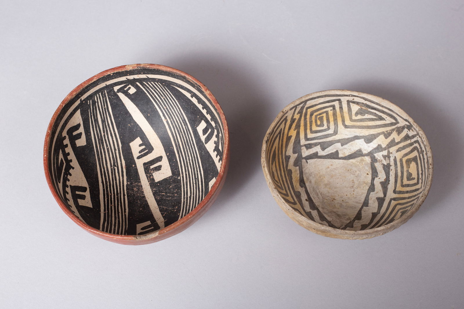 Group of Two Anasazi Bowls, Ca 1000 - 1350 AD: Group of Two Anasazi Bowls: A) Small B&W inside and corrugation outside 5 5/8"D, 2 3/4"H B) Gila Black on buff on red polychrome bowl 6 1/4"D, 3"H Provenance: Major & Nan Spessard Collection
