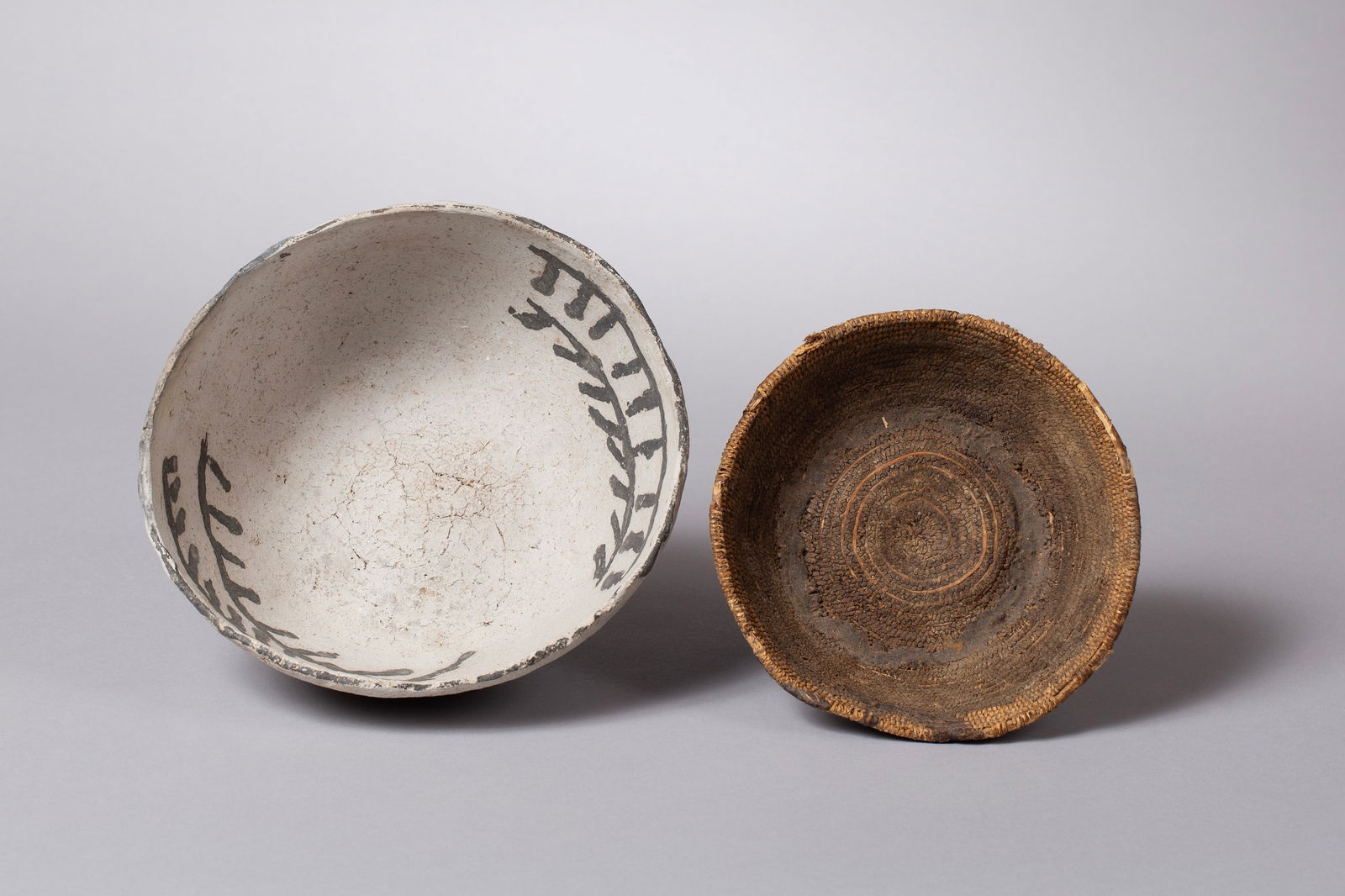 Important Grouping Consisting of a Basketmaker Basket and an Elusive Pithouse Bowl, Ca 500: Group of Two Early Pre-Mesa Verde Anasazi Items Found Together and important as such: A) Very early Chapin black and white pithouse bowl with impression of basket 7 1/2"D, 3"H B) Very fine early baske