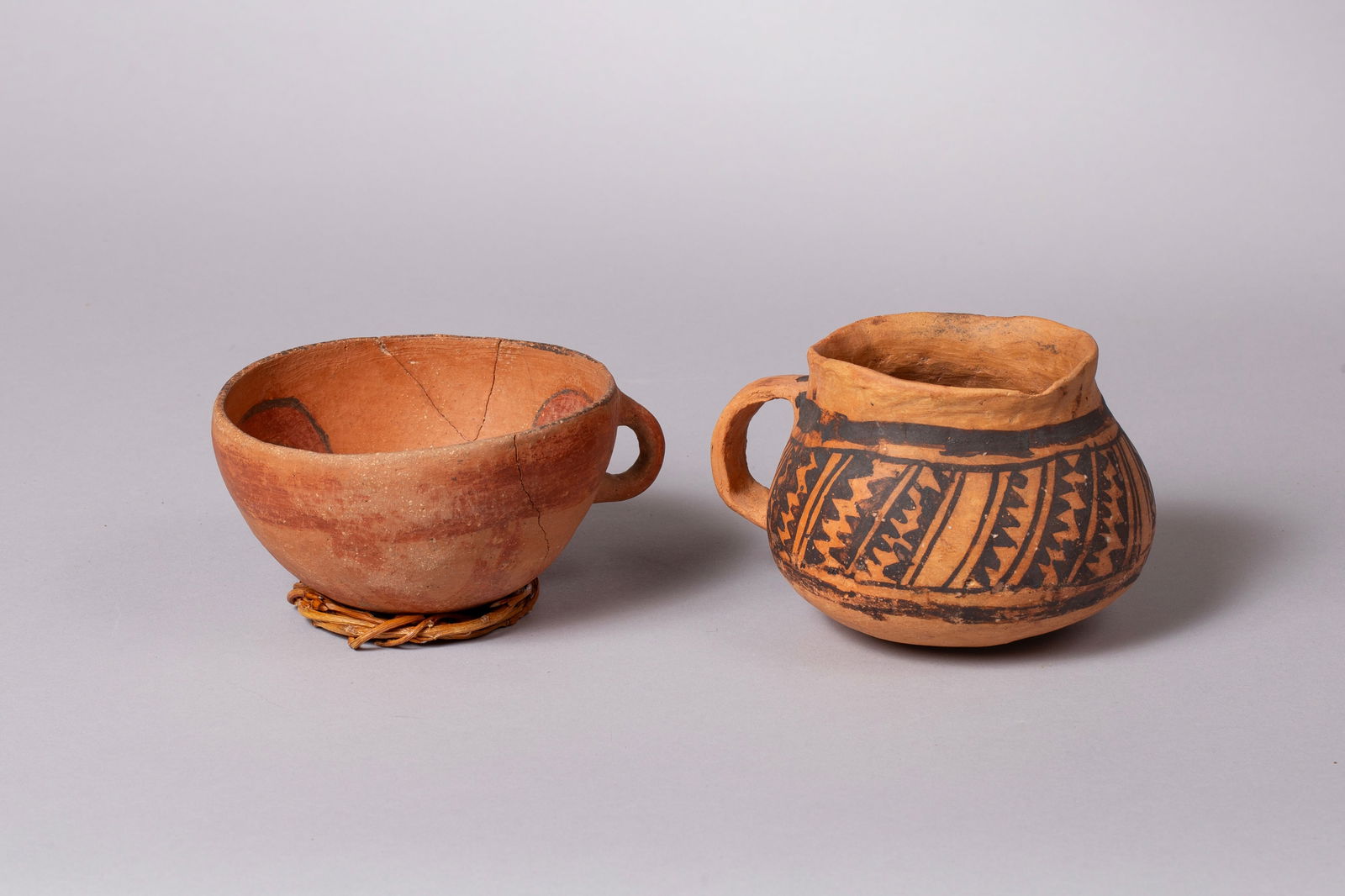 Two Anasazi Polychrome Bowls including a Citadel example, Ca 1040 - 1200 AD: Group of Two Polychrome Cups: A) Citadel polychrome cup - red with red and black designs inside, small handle 5"D, 2 3/4"H B) Black on orange mug with small handle 4 3/4"D, 5 3/4"W with handle, 3 1/2"