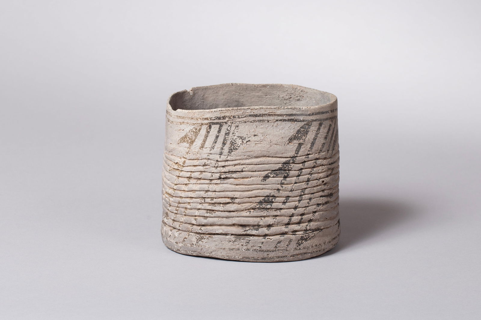 Scarce Piedra Coiled Black on Gray Seed Jar, Ca 850 - 950 AD: Piedra Coiled Black on Gray Oblong Pot with Two Suspension Holes 6 1/4"L, 4 5/8"W, 6 1/4"H Twenty to thirty percent restoration. Provenance: Major & Nan Spessard Collection