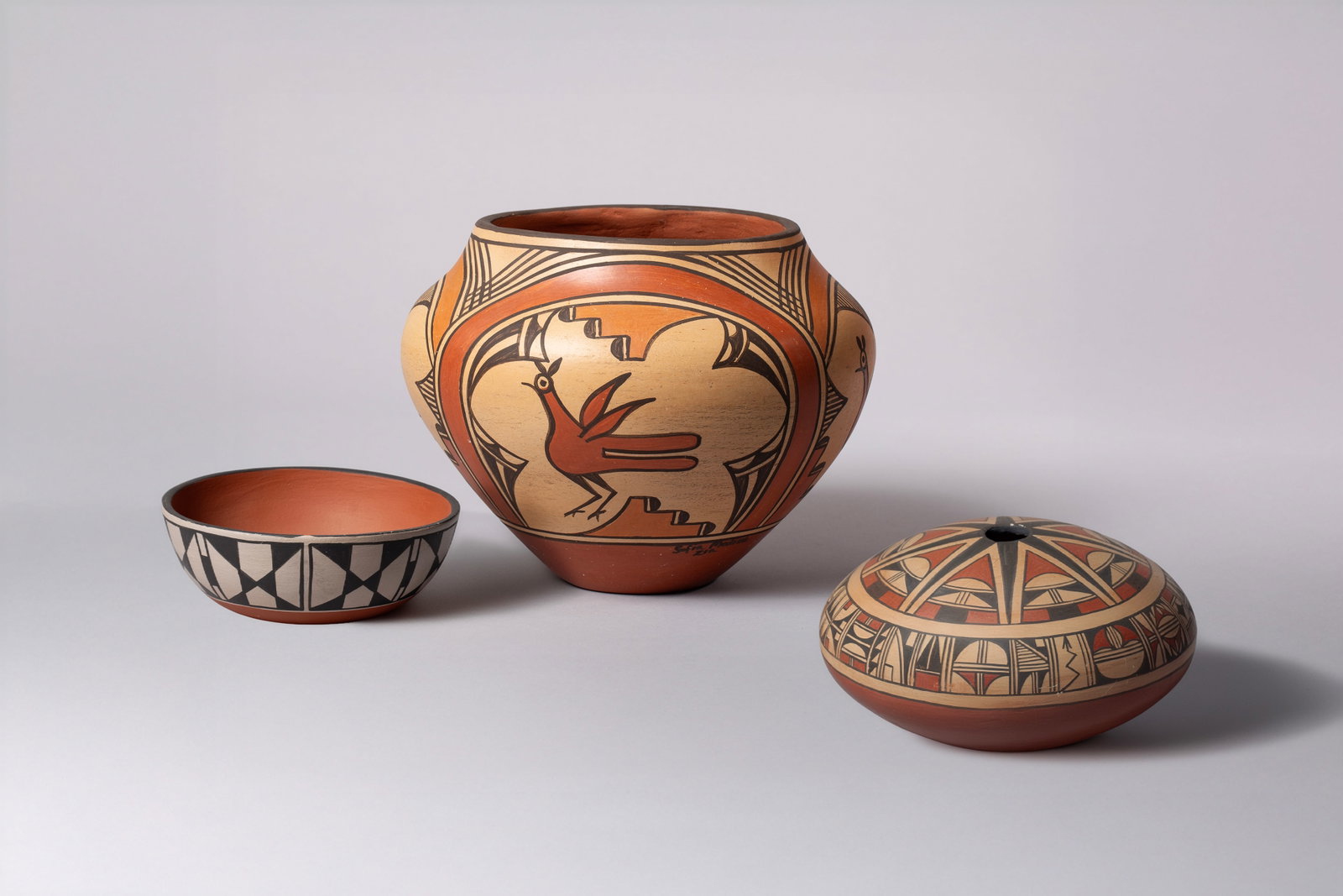 Three Interesting Pueblo Pots including a Zuni Decorated Seed Pot, a Zia Pot by Sofia Medina (1932 -: Three Pueblo Pots: A) Zuni Decorated Seed Pot (Unsigned) 7"D, 4"H B) Zia Pot by Sofia Medina 9"D, 7 1/2"H C) Santa Domingo Bowl marked SDP TP DT and corn cipher picture which represents Santa Domingo 
