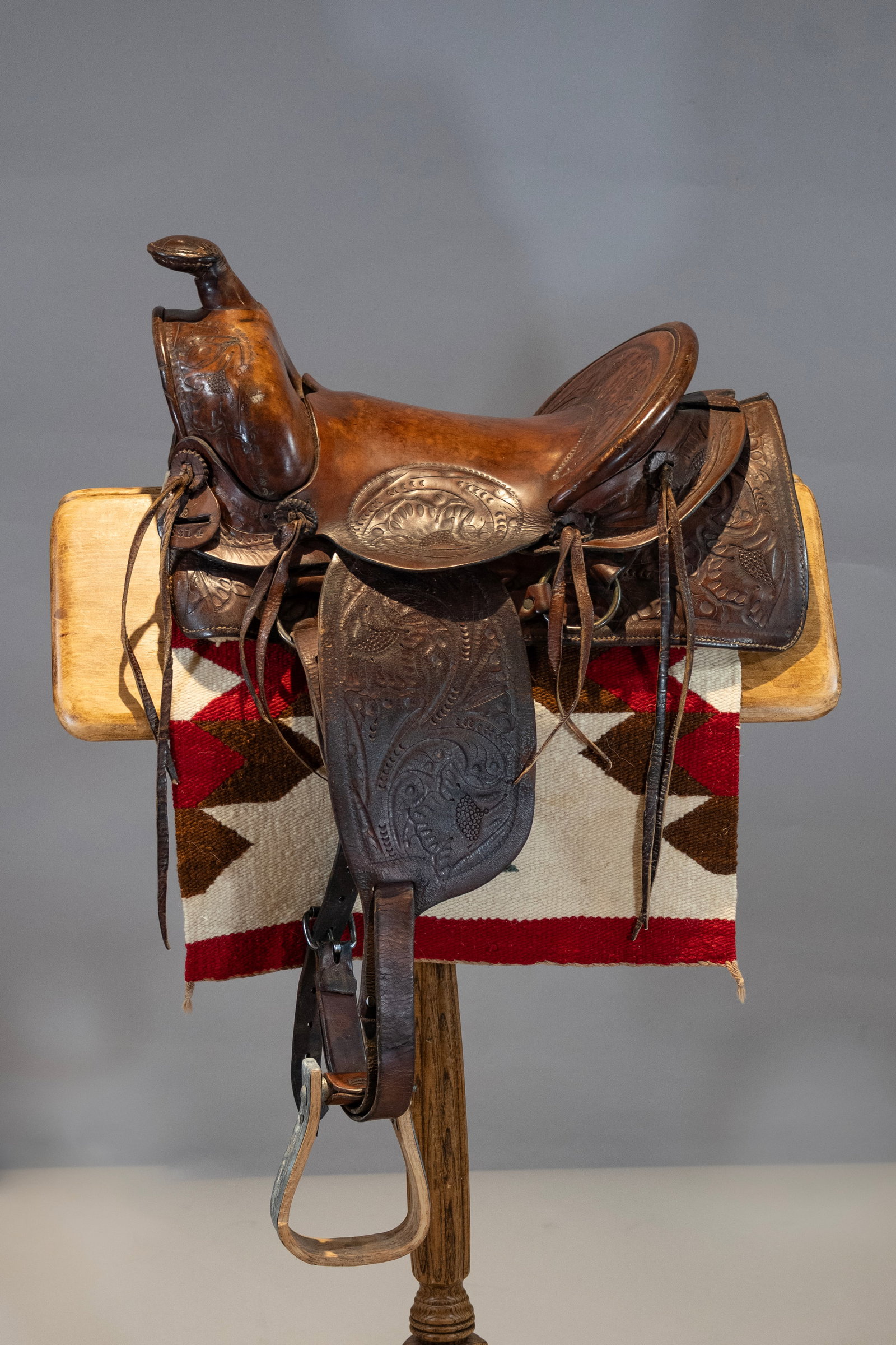 Child's Saddle with Saddle Blanket: A finely tooled child's saddle with saddle blanket. 12" seat, 36" x 17" saddle blanket
