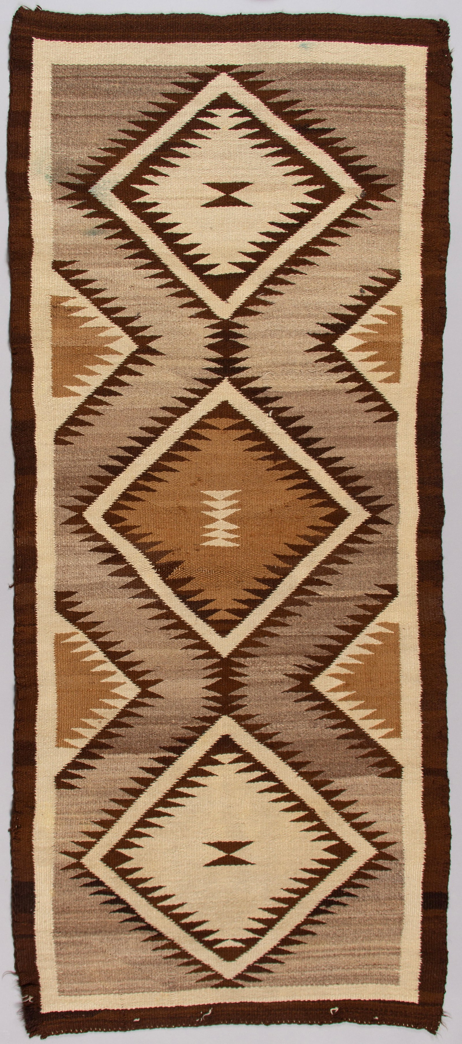 Exceptional Hand-Woven Navajo "Two Grey Hills" Regional Rug Runner: This is a fine example of a Native American Navajo rug in the highly sought-after "Two Grey Hills" style, characterized by its use of natural, undyed wool. This striking runner displays the intricate,