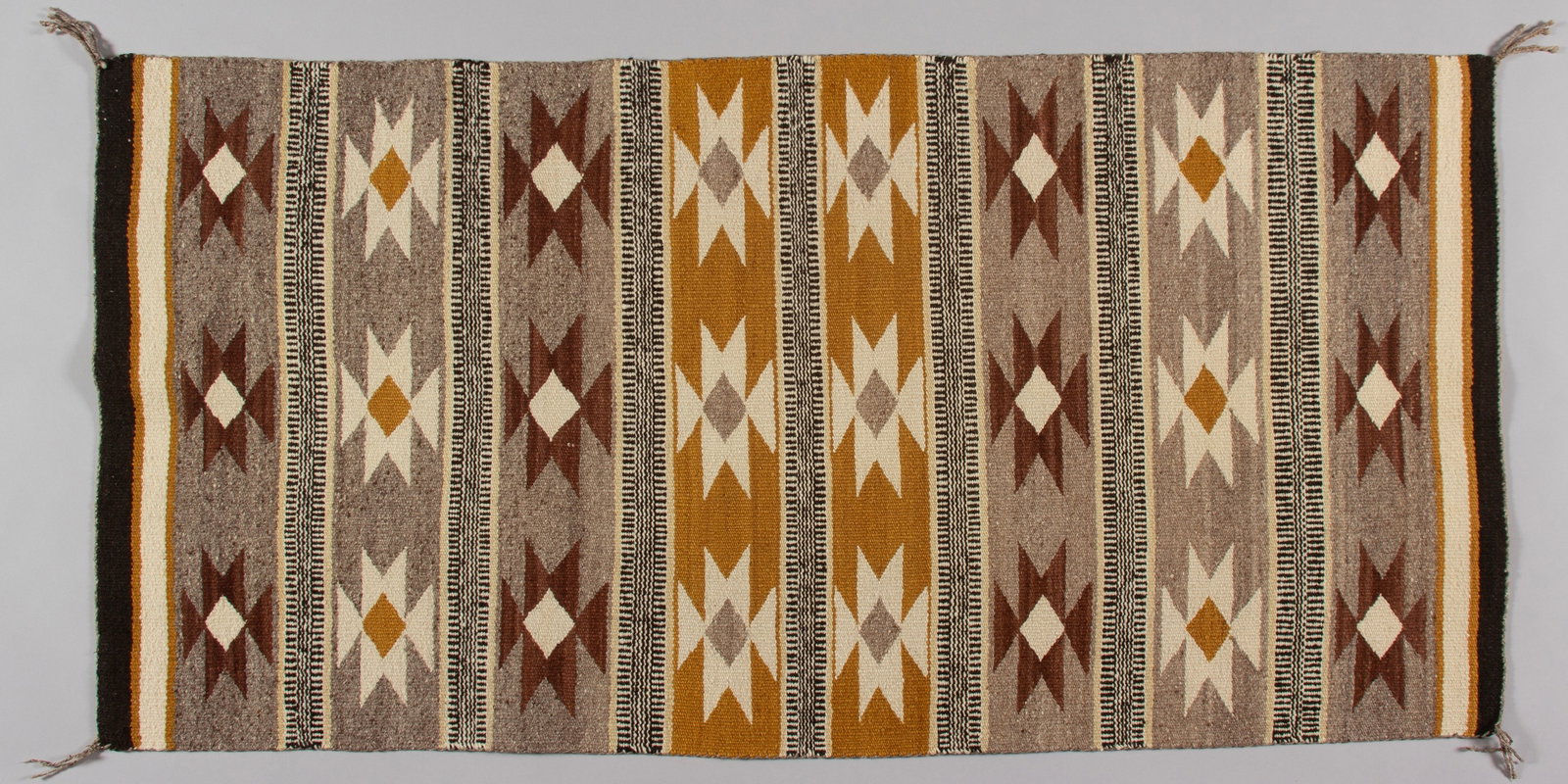 Vintage Navajo Wide Ruins Style Weaving: A beautiful, hand-woven Navajo textile, identified by its classic banded pattern and natural color palette as a Wide Ruins regional style rug. This piece showcases traditional geometric motifs, includ