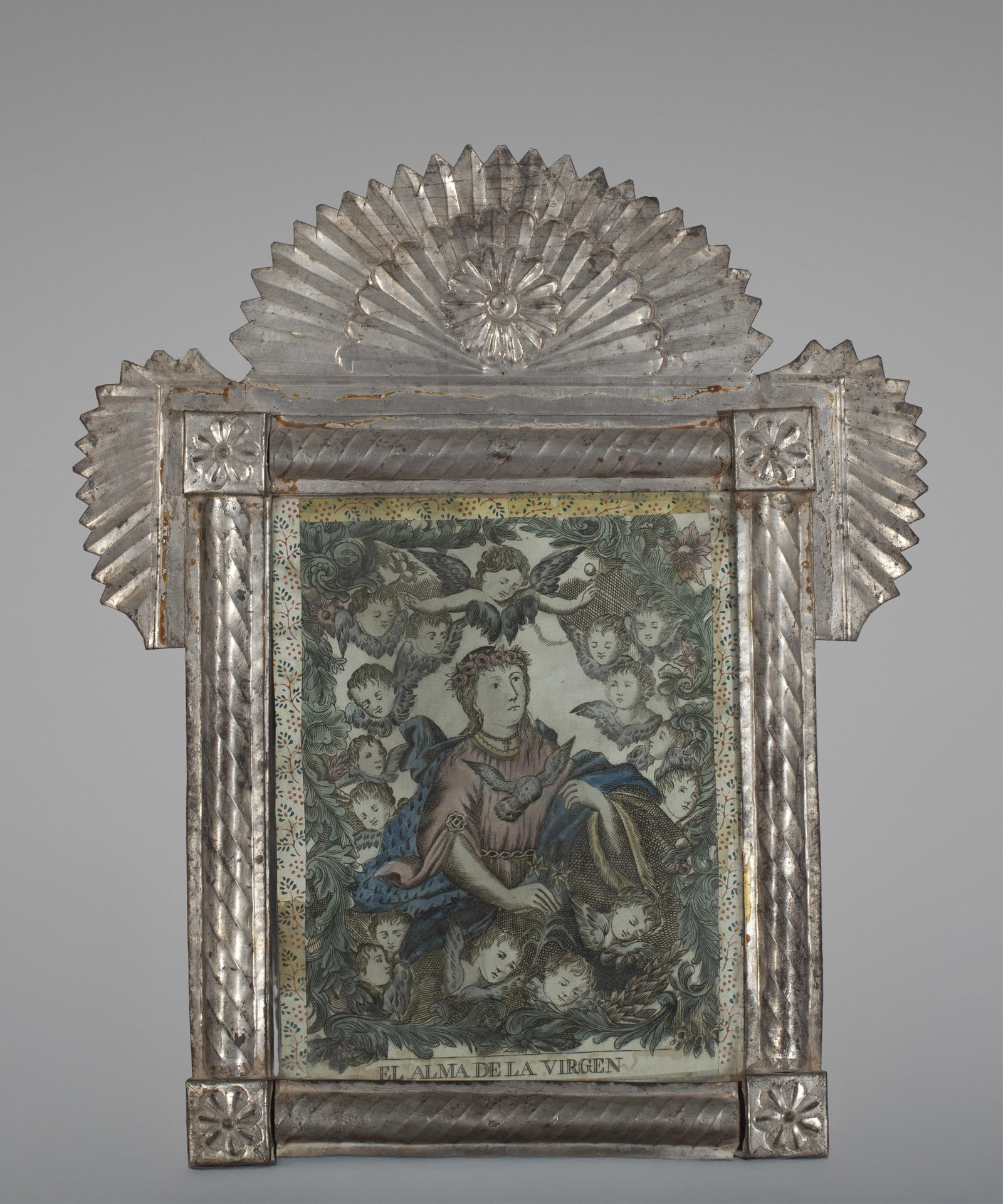 New Mexican Tin Frame Titled "El Alma De La Virgen" c. 1880-1900: This rare piece of New Mexico devotional art features a lithograph titled "El Alma De La Virgen" (The Soul of the Virgin" housed in traditional 19th century tinwork frame. A prominent sunburst style f