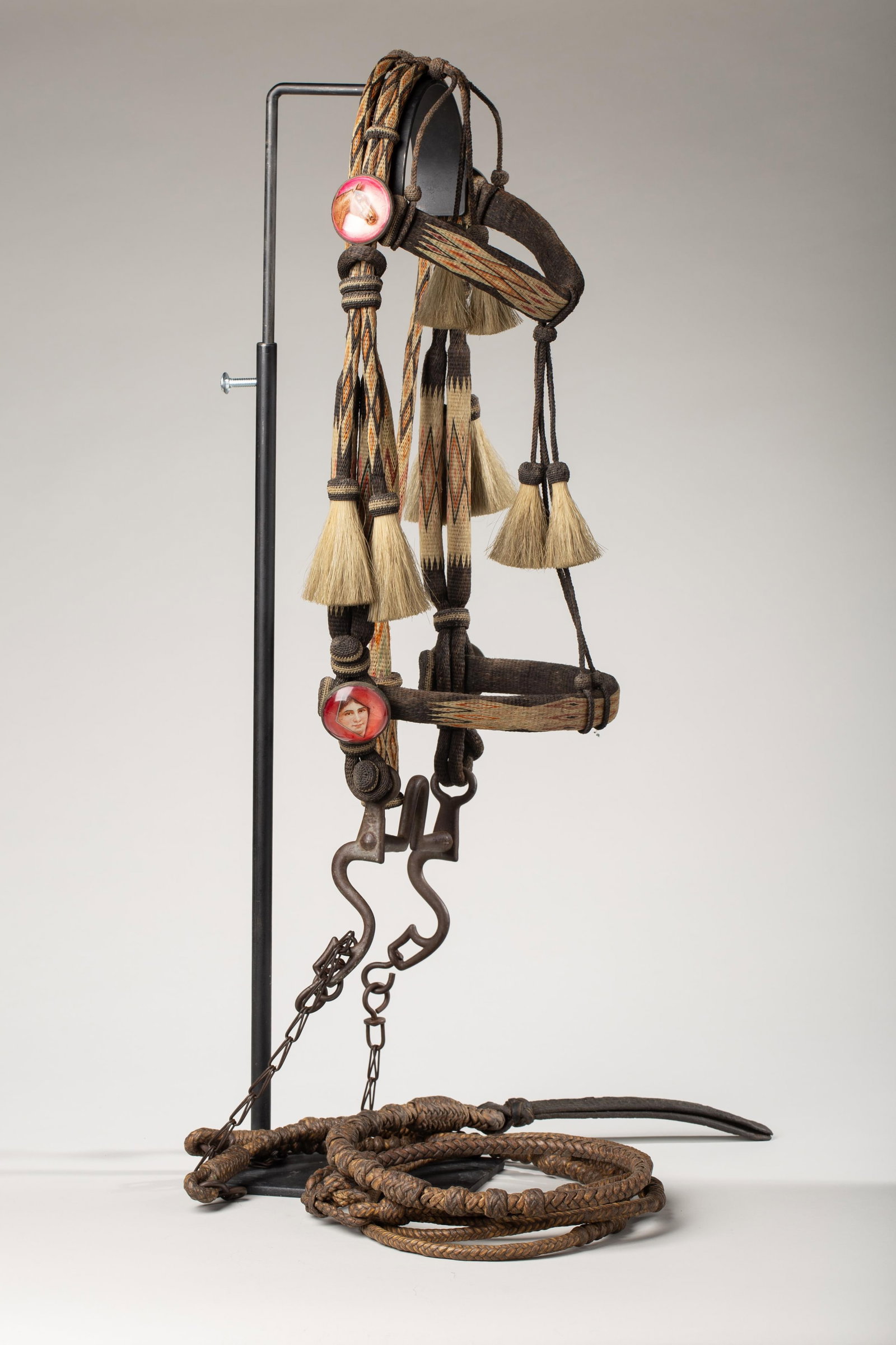 Stunning Deer Lodge Hitched Horsehair Prison Bridle: Deer Lodge Hitched Horsehair Prison bridle. Constructed of finely hitched and braided horsehair in a variety of natural and dyed colors, featuring classic diamond patterns. The craftsmanship showcases