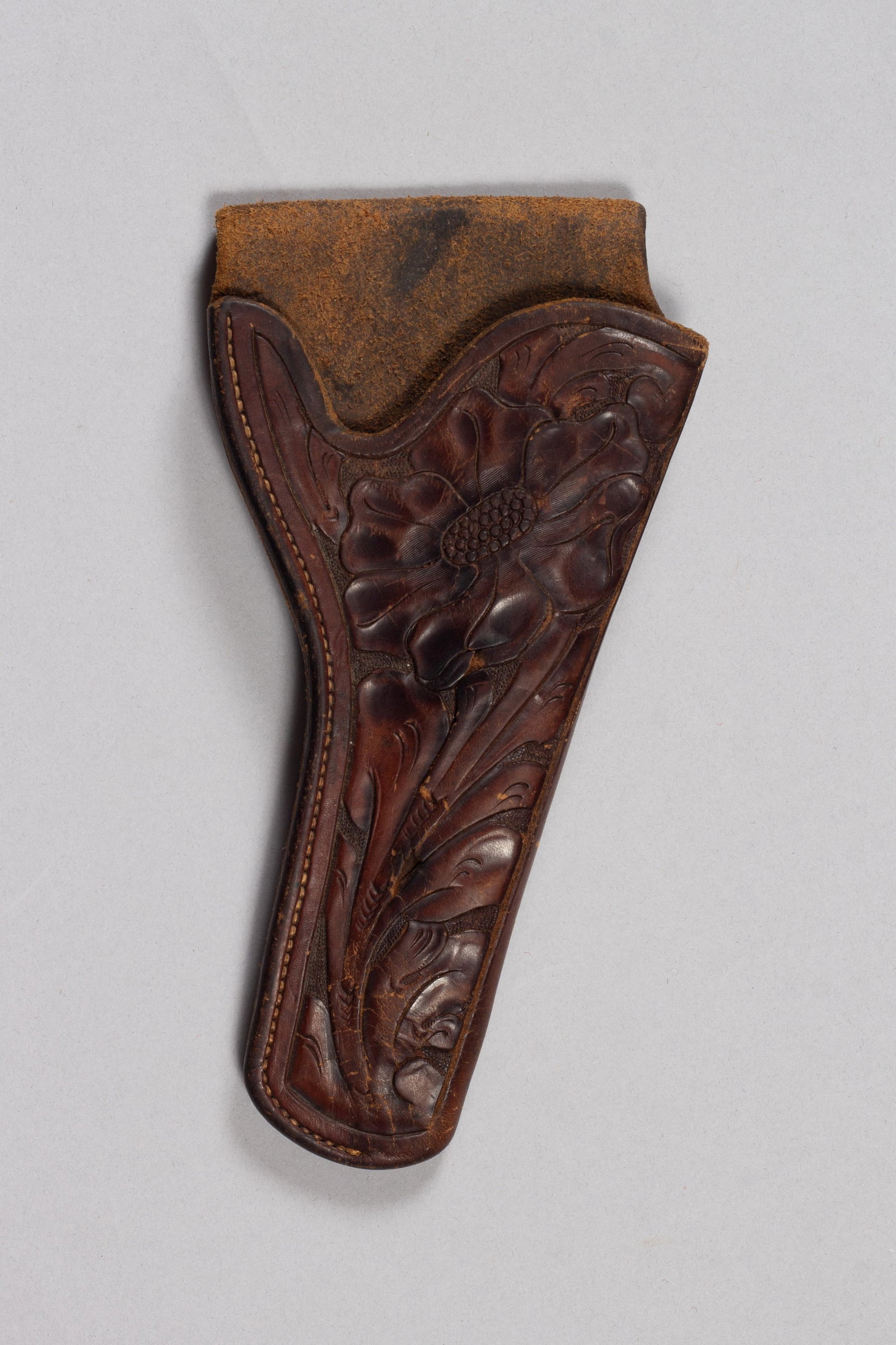 New Mexico Marked Holster, John Ratton Lordsburg: Vintage New Mexico stamped holster by John Rattan Lordsburg, NM. A classic, handmade leather holster featuring exquisite, detailed floral tooling that reflects the artistry of John Rattan. Fits a