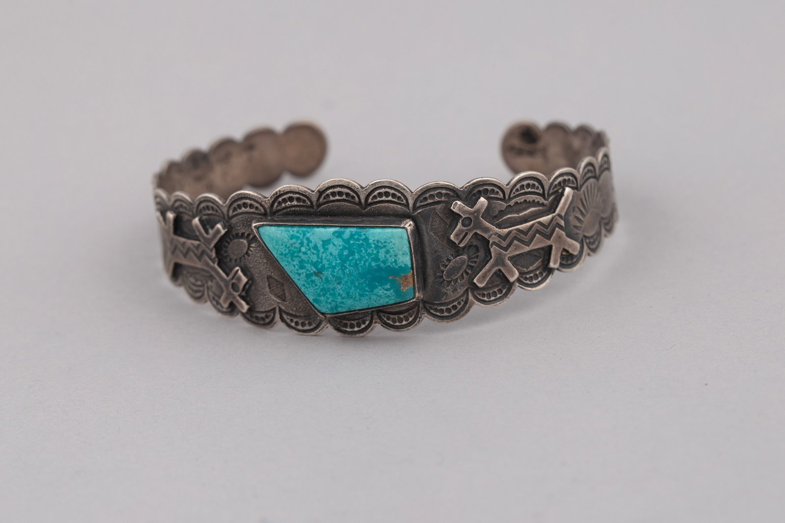 A Vintage Fred Harvey Era Native American Silver and Turquoise Cuff Bracelet with Dog Elements 2 1/4 (1 of 4)