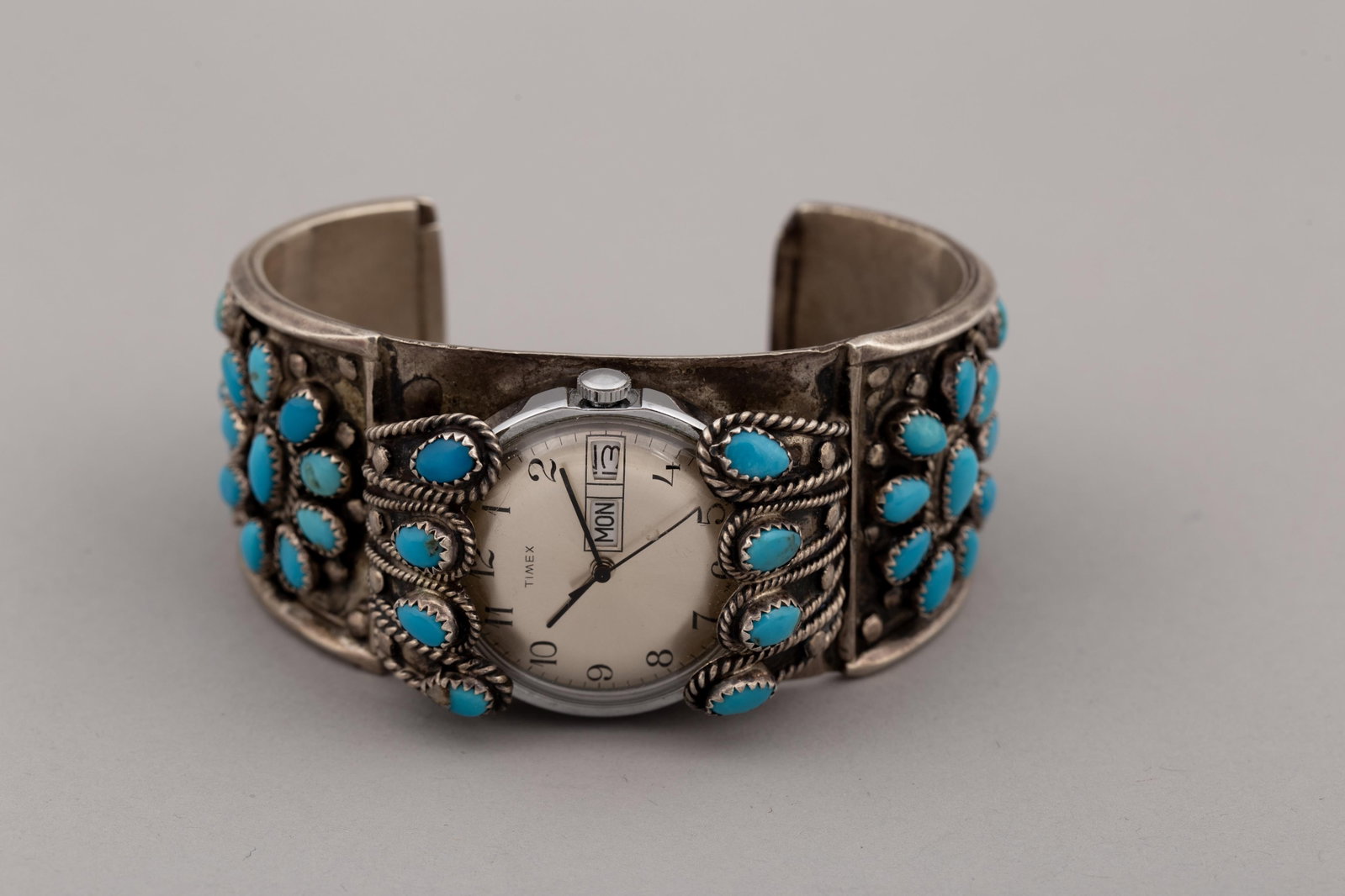 Vintage Navajo Sterling Silver & Turquoise Cluster Watch Cuff Bracelet by JM Begay: Stamped JM Begay on reverse.Handcrafted by renowned Navajo silversmith JM Begay (Johnny Mike Begay). This heavy-gauge sterling silver cuff showcases traditional Southwestern silversmithing artistry, m