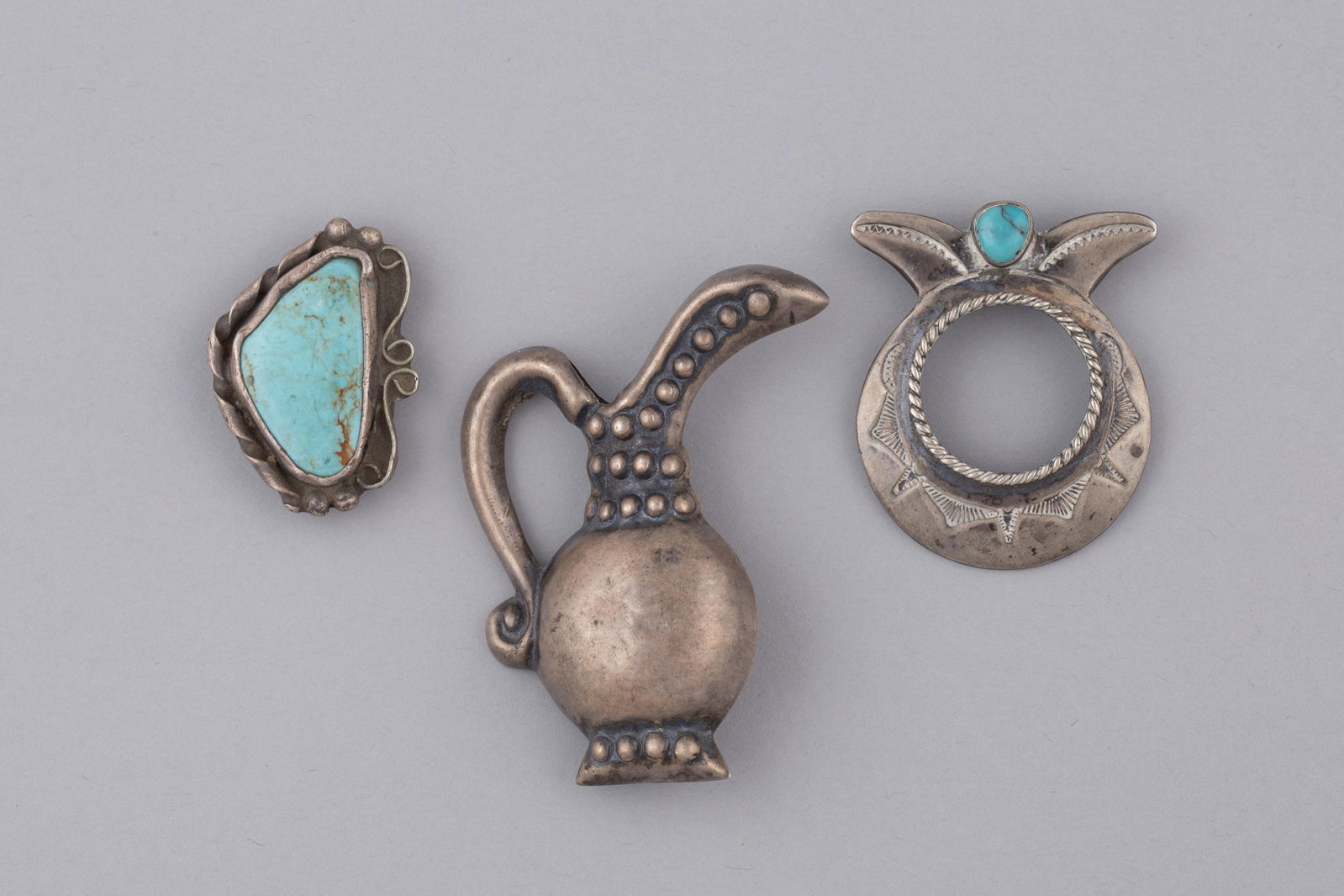 Three Vintage Native American & Mexican Silver Jewelry Pieces Pitcher Pin: 2 1/2 x 2 x 1/2 in. (6.4: An attractive three-piece collection of vintage sterling silver jewelry showcasing classic Southwestern Native American and Mexican silversmith artistry.(A) Vintage Navajo Sterling Silver Turquoise Sc