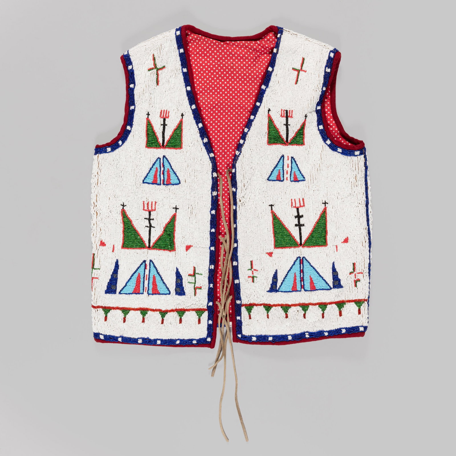 Contemporary Sioux Beaded Vest: This contemporary vest is a striking example of modern Sioux beadwork artistry, drawing deep inspiration from traditional 19th-century Plains Indian aesthetics. Decorated with stacked tepee (tipi) des