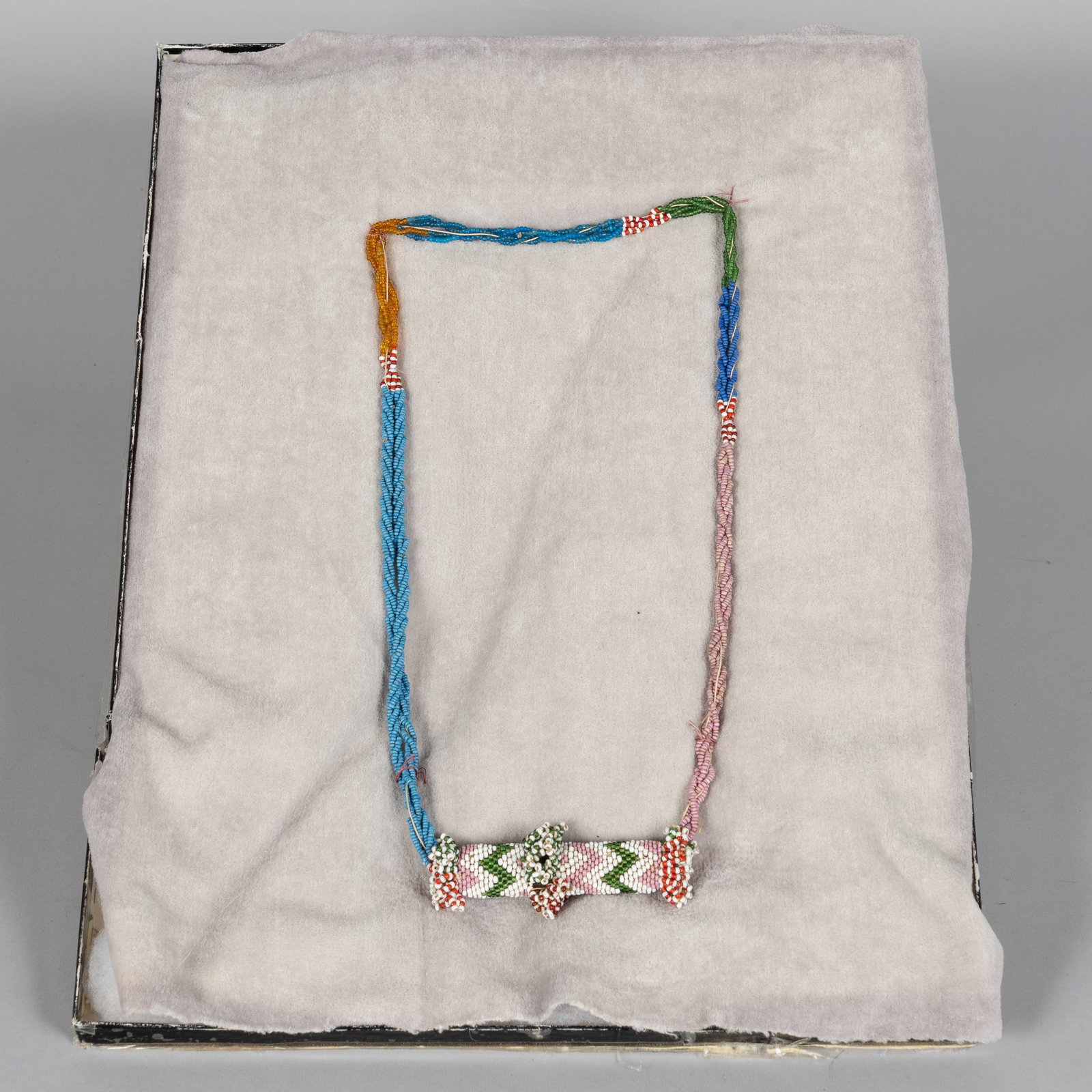 Historic Apache Beaded "Compartment" Necklace: A highly unusual Apache beaded "compartment" necklace, dating to Ca 1880. The upper portion features twin strands of finely strung light blue and dark blue seed beads, which lead down to a central,