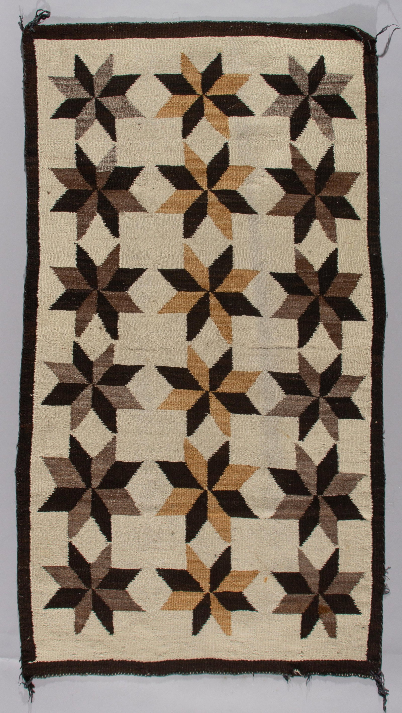 Antique Navajo Valero Star Weaving, Crystal Region, Ca 1920s: A fine example of early 20th-century Navajo textile artistry, this rug showcases the distinctive Valero Star pattern, a motif thought to be influenced by Spanish colonial designs. This specific style 