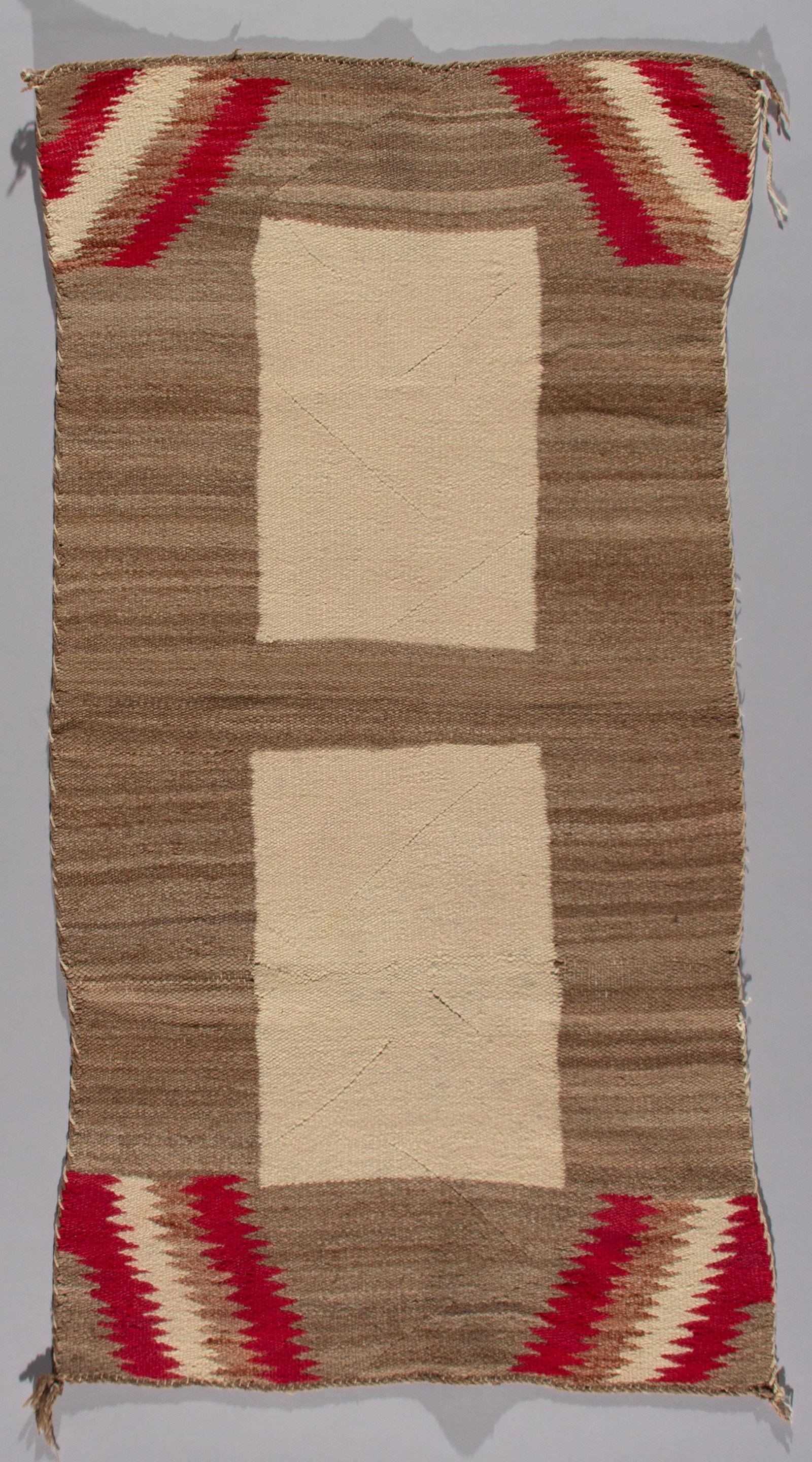 Navajo Double Saddle Blanket, Ca 1910s: A fine example of early 20th-century Navajo weaving, this double saddle blanket is woven in super soft, handspun wool. The design features two large, rectangular cream-colored panels centered vertical