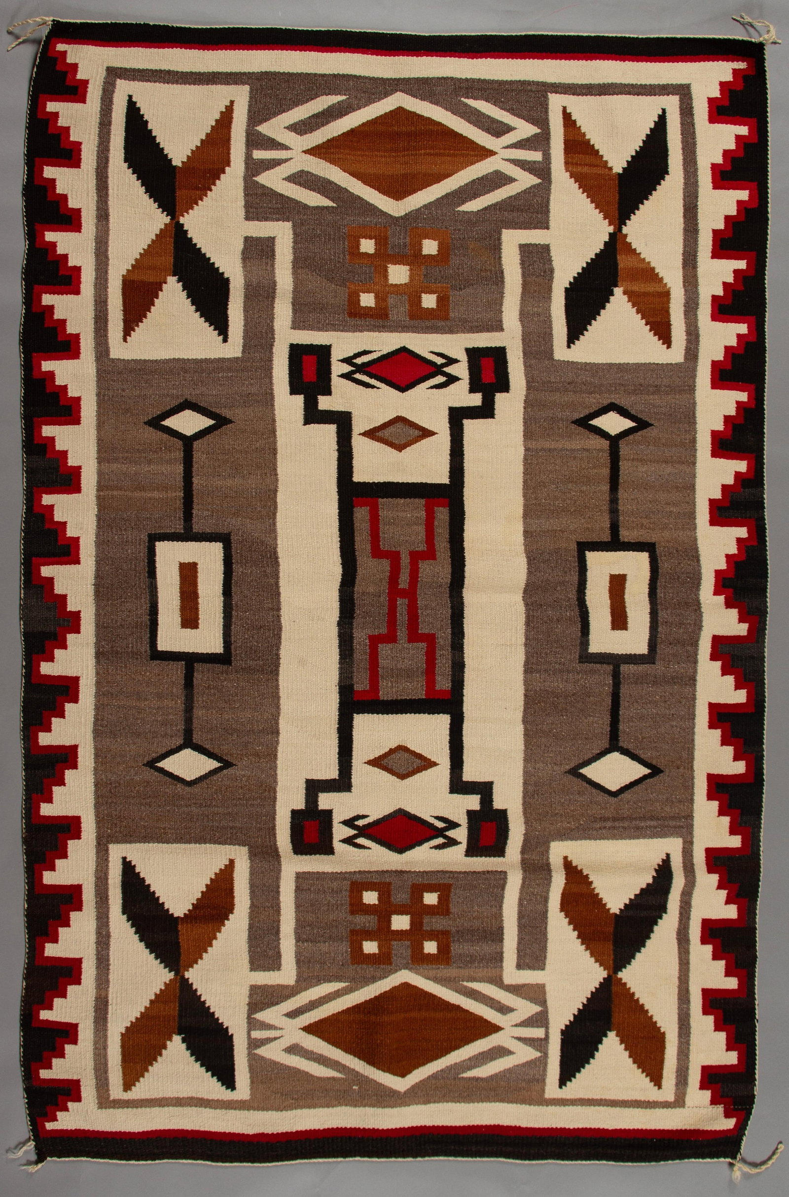 Navajo Strom Pattern Rug J.B. Moore, Ca 1940s: A finely woven Navajo rug featuring the iconic "Storm Pattern" design, a style popularized by trader J.B. Moore at the Crystal Trading Post in the early 20th century. The design elements are rich in s