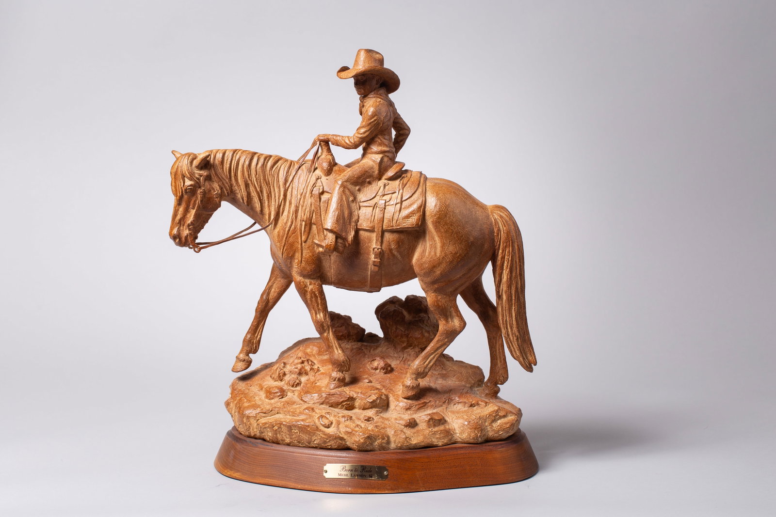 Mehl Lawson (b. 1942), Born to Ride: signed Mehl Lawson CA and editioned 4/35 on baseThis western-themed bronze sculpture is titled "Born to Ride" by acclaimed Mehl Lawson, depicting a young cowboy riding a horse. Crafted from bronze, fe