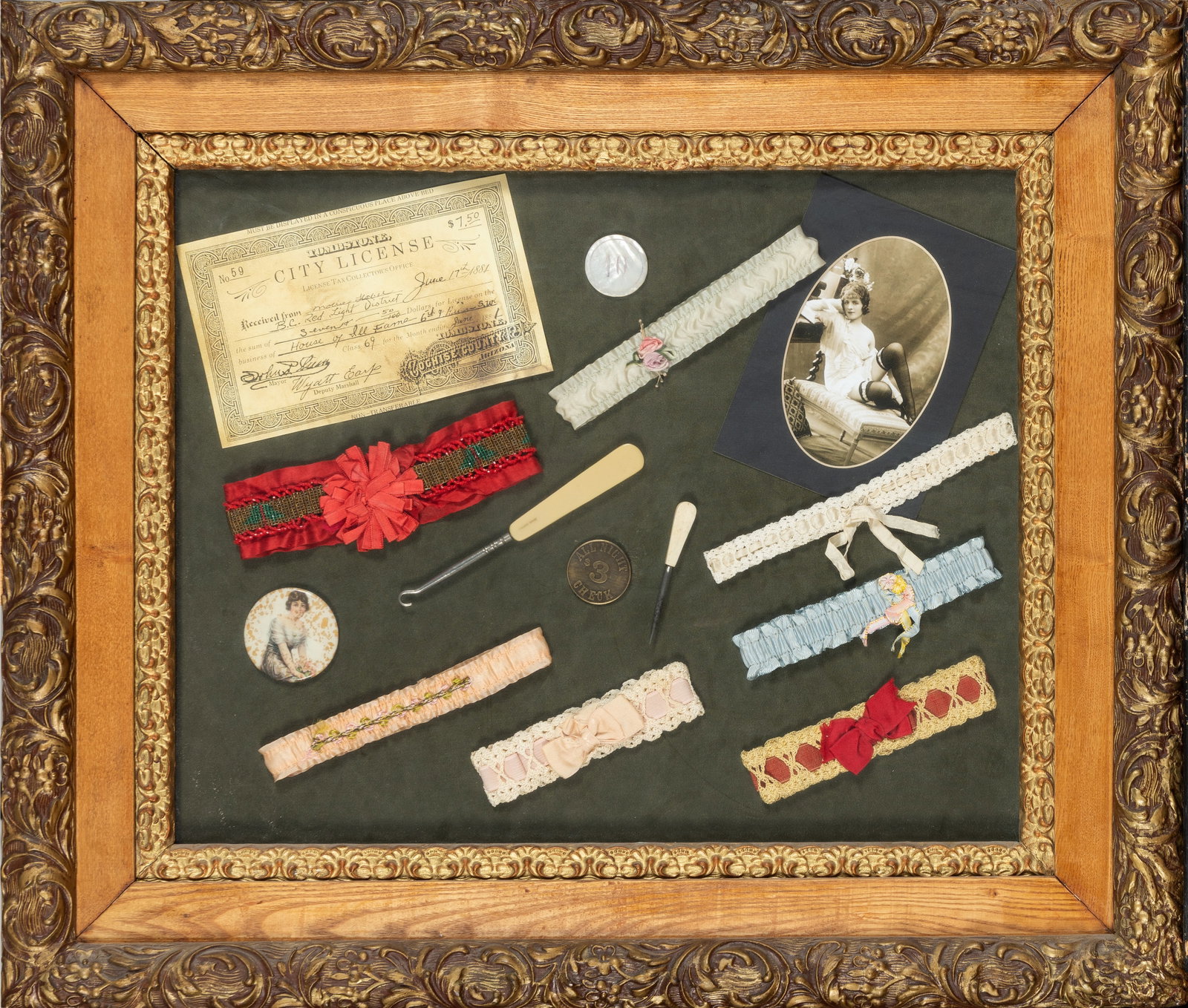 Antique Style "Saloon Gal" Memorabilia Garter Shadow Box Display: An evocative, antique-style shadow box presentation celebrating Old West cabaret and "Saloon Gal" culture. The collection features a curated assortment of vintage-inspired memorabilia elegantly arrang
