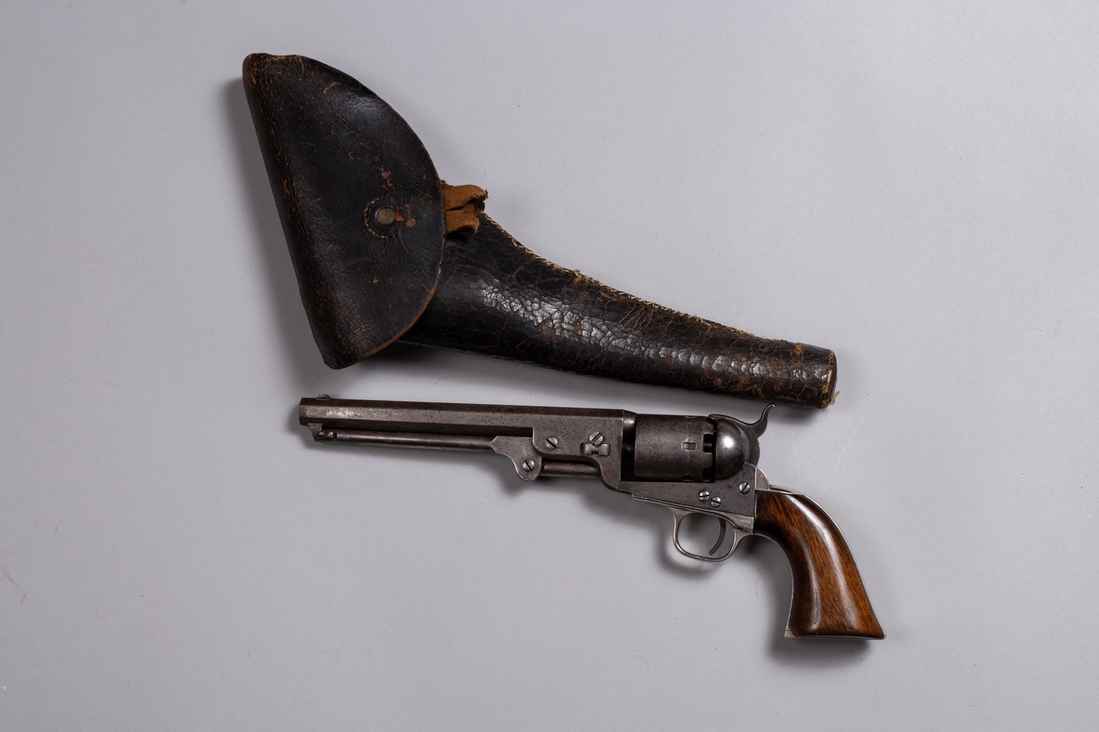 Colt 1851 Navy Revolver with Holster: Colt Model 1851 Navy Revolver, one of the most iconic sidearms of the 19th century. All matching Serial numbers 204387, with faint scene on cylinder. This revolver was manufactured in 1867 at Colt's H