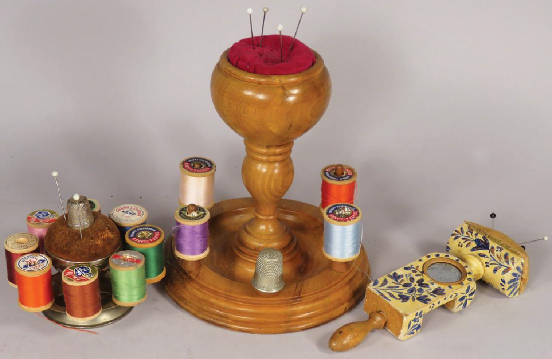 Collection of Early Sewing Items: Collection of Early Sewing Items, ca. 1900. Two sewing reels topped with pin cushions and decorative wood clamp topped with pin cushion. Complete with thread and thimbles. Largest measures 6 inch diam