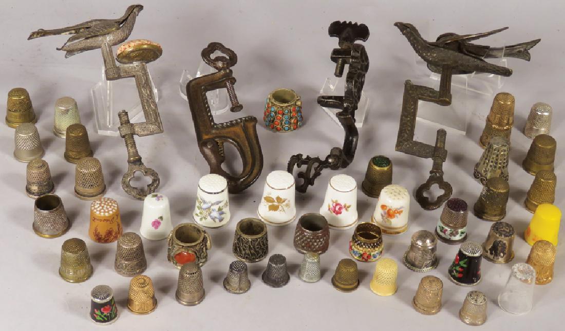 Collection of Early Sewing Items: Collection of Early Sewing Thimbles. 43 total pieces include brass, sterling silver, bone china, glass topped, stone décor, etched glass and more. 2 Rare hemming birds, cast iron duck and decorative