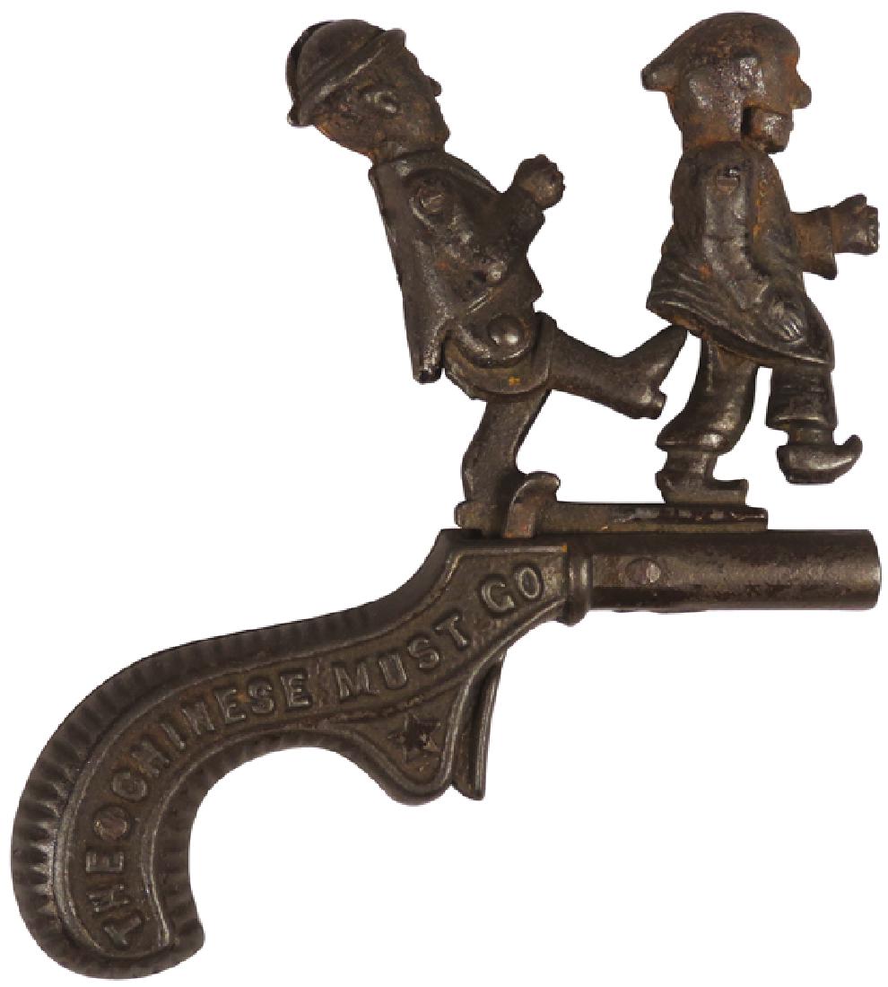 Cast Iron Cap Gun, The Chinese Must Go: Cast Iron Cap Gun, The Chinese Must Go, mfg. by Ives. Trigger releases foot to boot the Chinaman, patd 1879. 5 X 4 inches.