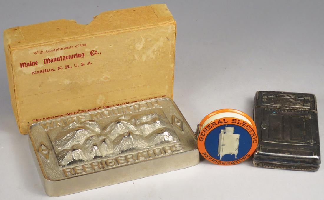 Collection of Refrigerator Advertising Items: Collection of Refrigerator Advertising Items. White Mountain Refrigerators paperweight and match holder. General Electric celluloid tape measurE Paperweight measures 4 inches widE