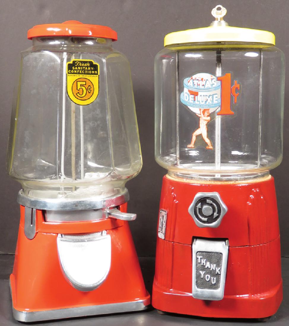 Two Vending Machines: Two Vending Machines. Bloyd MfG Co. 5 cent vendor and Atlas Deluxe (w/key). Both in good working condition. Tallest measures 15 inches.