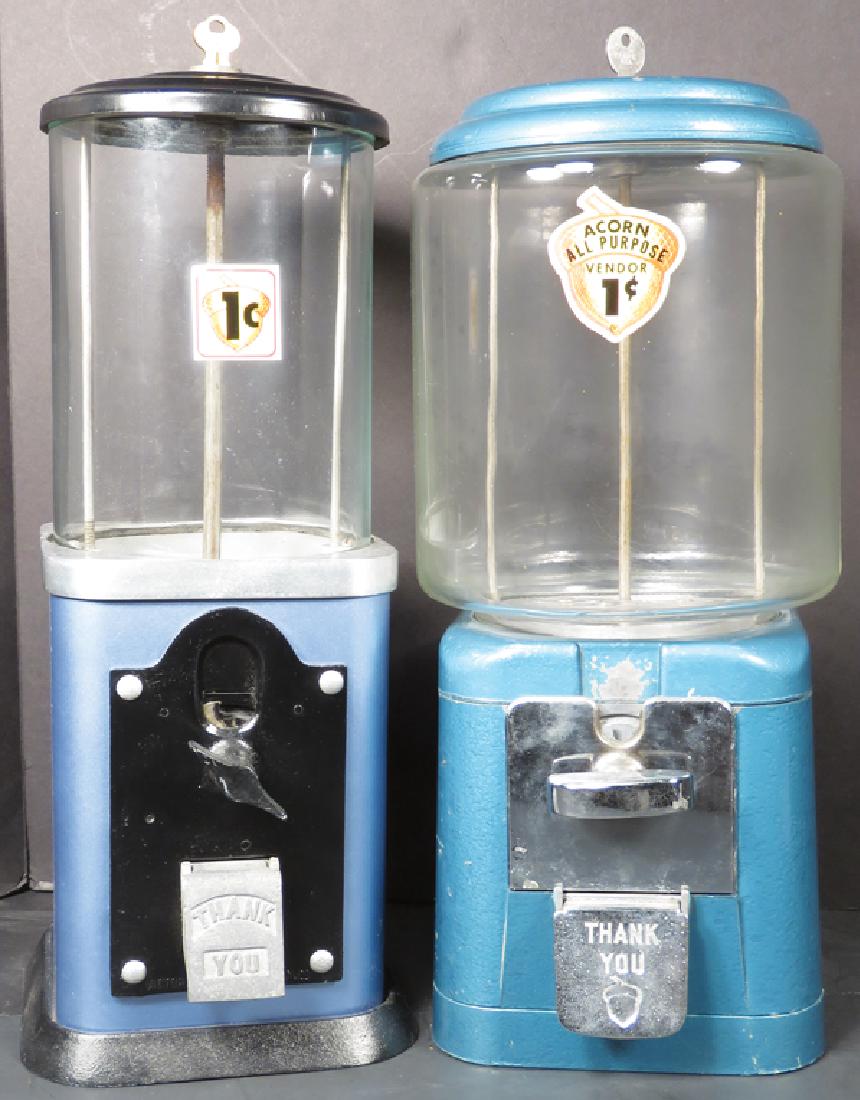Two Vending Machines: Two Vending Machines. Blue Acorn All Purpose One Cent machine and Victor Vending Corp. Both in good working condition, come with keys. Tallest measures 16 inches.