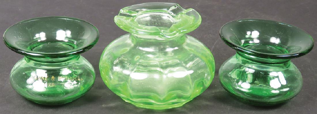 Three Antique Ladies Hand Held Spittoons: Three Antique Ladies Hand Held Spittoons. Green glass. Large one has cigarette/cigar holders around edge, 3 3/4 X 2 1/2 inches.