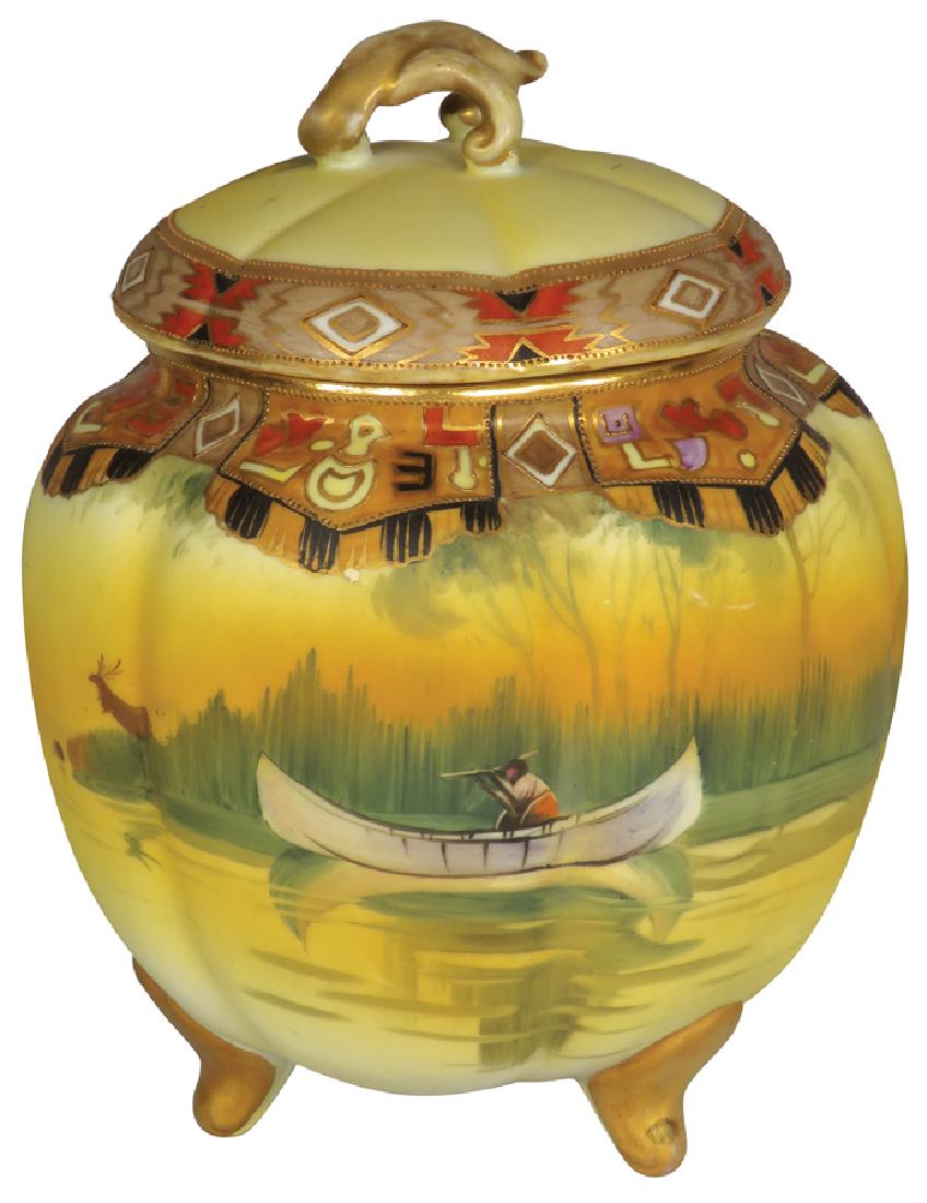 Nippon Hand Painted Porcelain Biscuit Jar: Nippon Hand Painted Porcelain Biscuit Jar. Native Indian in canoe motif. No chips or cracks. 8 1/4 inches tall.