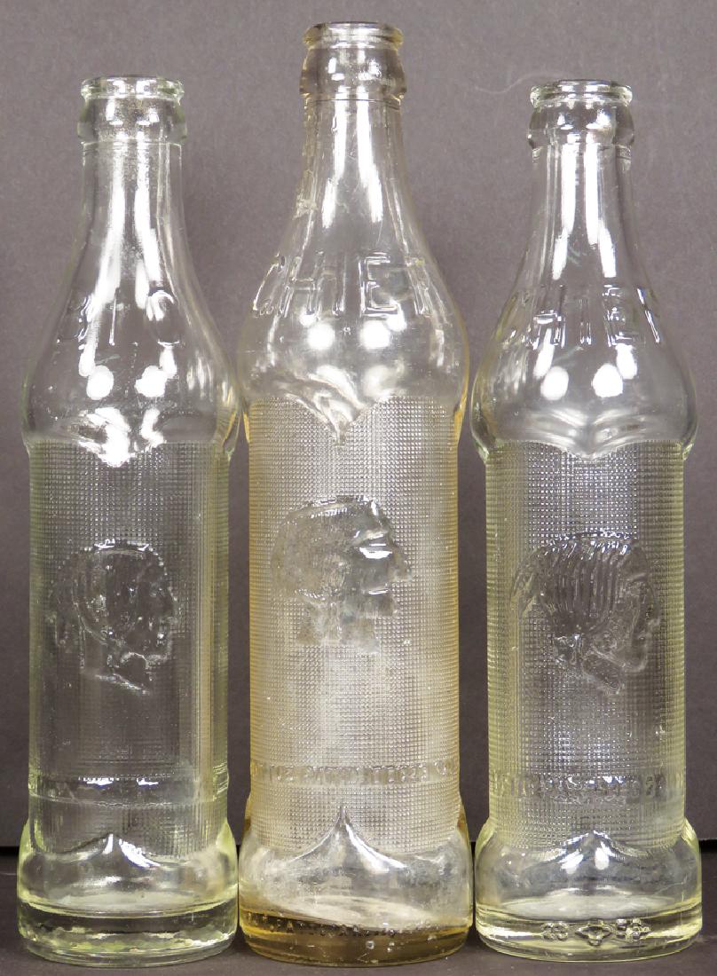 Three Big Chief Embossed Soda Bottles: Three Big Chief Embossed Soda Bottles. Clear glass, 7 and 9 oz. bottles. No chips or cracks. Near Mint.
