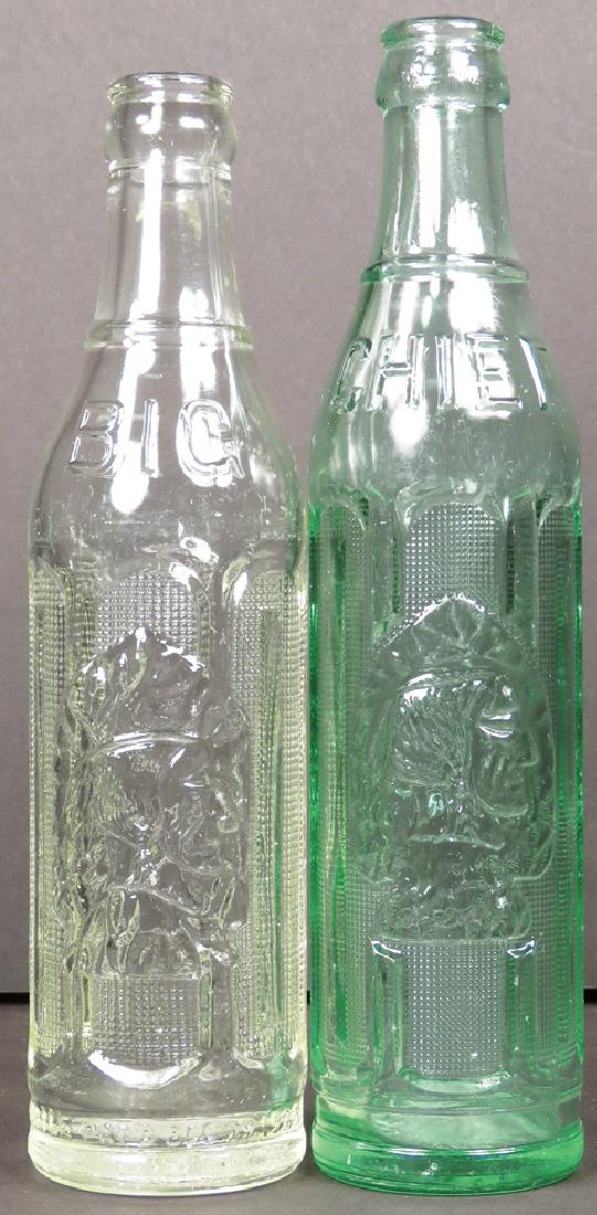 Two Big Chief Embossed Soda Bottles: Two Big Chief Embossed Soda Bottles. Clear and green glass, patent date 1925. 8 oz. bottles. No chips or cracks. Near Mint.