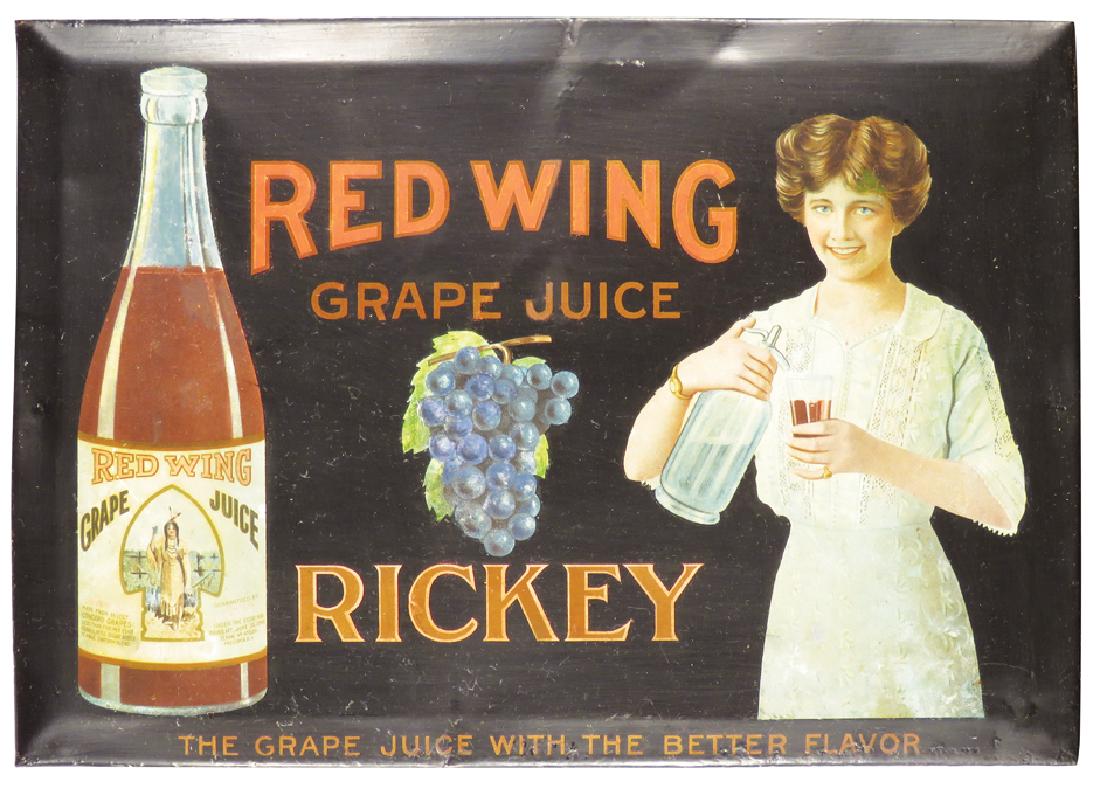 Red Wing Grape Juice Tin Over Cardboard Sign: Red Wing Grape Juice Beveled Tin Over Cardboard String Hanging Sign. Native American Indian Motif. Restored condition. 3 1/4 X 9 inches.