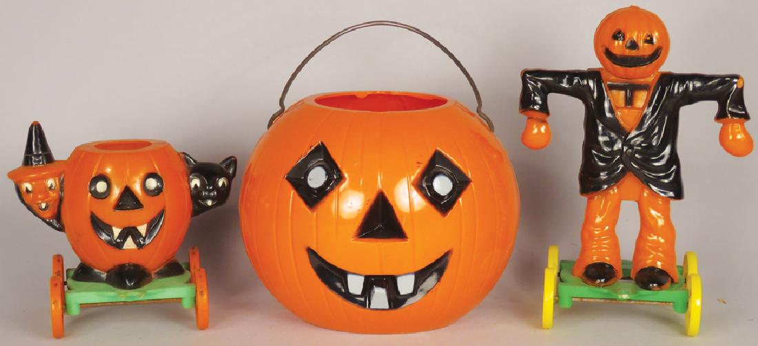 Collection of Vintage Plastic Halloween Items: Collection of Vintage Plastic Halloween Items. (3) Candy container/nut cups, two on wheels. Pumpkin measures 4 inches tall.