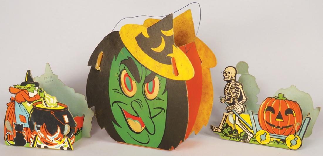 Collection of Vintage Cardboard Halloween Items: Collection of Vintage Cardboard Halloween Items. Dual-sided slot and tab candy containers and lantern. Candy containers marked G.M. Co. HR5-A/F, ca. 1950's. Lantern measures 6 X 6 1/2 X 2 1/2 inches.