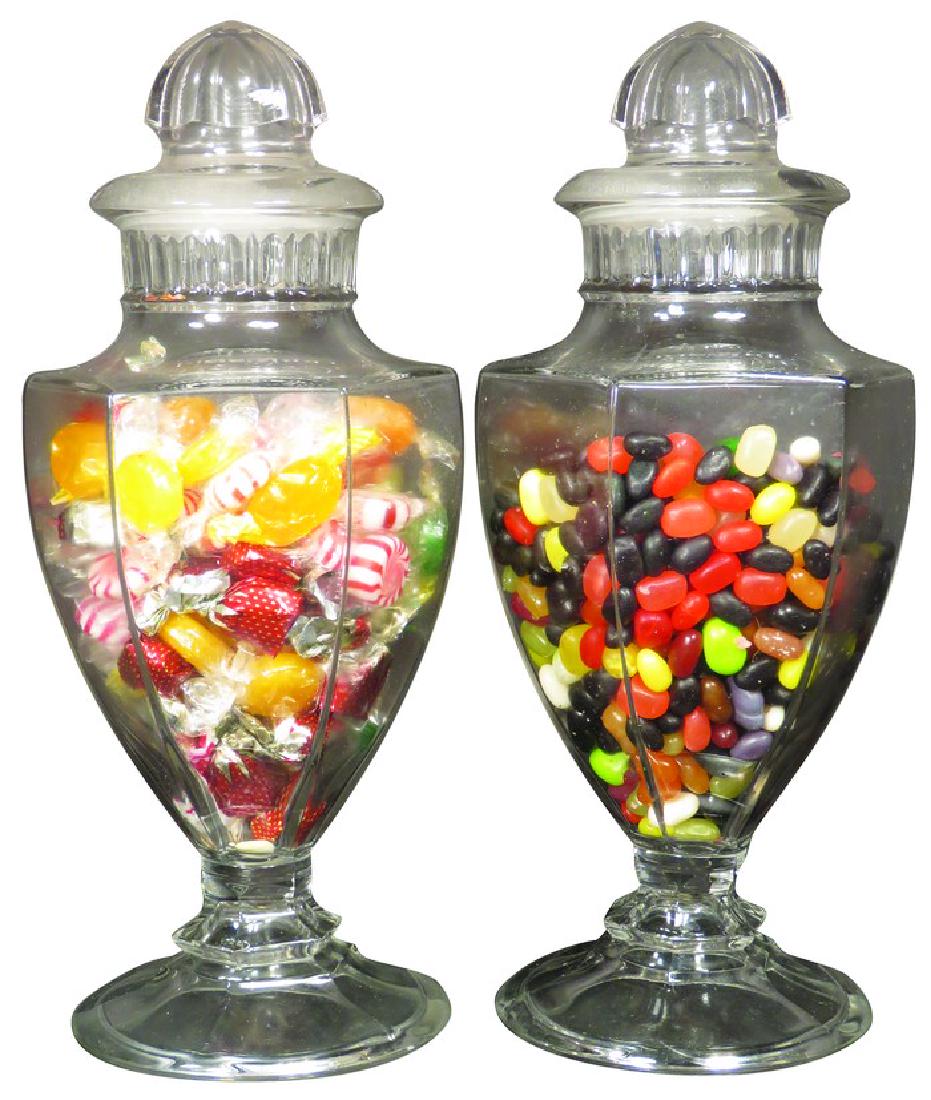 Pair of Puritan Glass Candy Jars: Pair of Puritan Glass Candy Jars with ground glass lid. Small chip on one lid otherwise excellent condition. Both measure 13 inches tall.