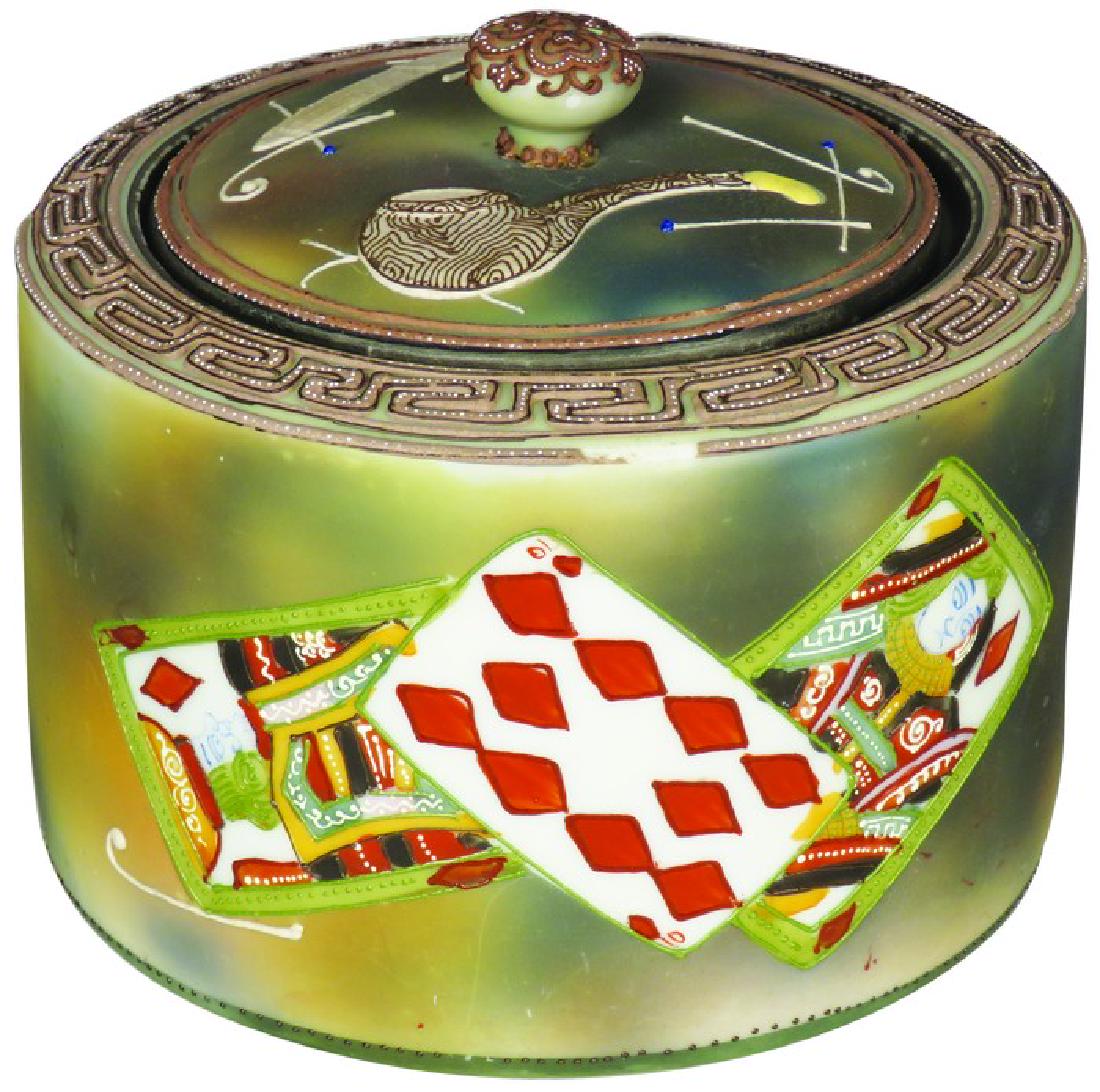 Nippon Hand Painted Porcelain Tobacco Humidor: Nippon Hand Painted Porcelain Tobacco Humidor. Card suit and smoking motif. Chips on top perimeter edge very good excellent condition. 5 1/2 inches tall X 6 inch diameter.