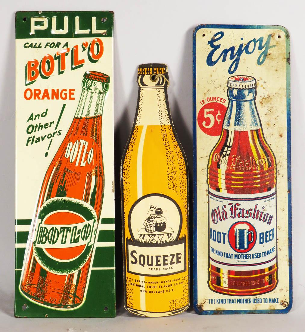 Three Soda Advertising Items: Three Soda Advertising Items. Old Fashion Root Beer tin door push, fair condition. Botl'o Orange embossed tin door push, very good condition. Orange Squeeze die cut cardboard fan pull, very good condi